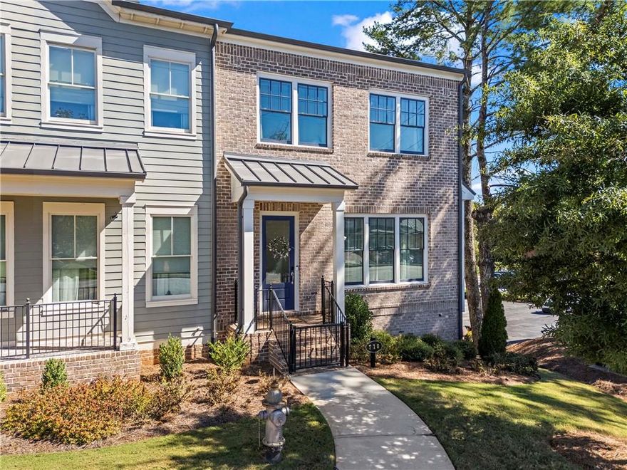 Welcome to one of Roswell’s most charming communities, Canopy! This like-new 3 bedroom, 3.5 bathroom end unit townhome offers a rare private fenced side yard and lives large with bright, open spaces + thoughtful upgrades throughout. The main level is both open and inviting, featuring a fireside living room, dining room, and a chef’s kitchen with a large island, bar seating for four, a large walk-in pantry, and stylish pendant lighting. Also found on the main level is an office or study nook plus a half bath. Don't miss the sizable outdoor deck, perfect for morning coffee or evening happy hour. Upstairs you’ll find a primary suite that offers a large custom walk-in closet and a spa-like bathroom with dual vanities. Two spacious secondary bedrooms, a secondary bathroom, and laundry complete the second level. The finished terrace level is a special treat for movie night! It features a full bathroom and barn doors that lead to a fourth bedroom, a home office, or gym. The oversized two-car garage offers excellent storage + a Tesla EV car charger. A community dog park is loved by many! Enjoy unbeatable access to local favorites with Roswell Junction, Summit Coffee, The Mill, and Souper Jenny just minutes away—and the beloved shops and restaurants of Canton Street only a short distance from your door.
