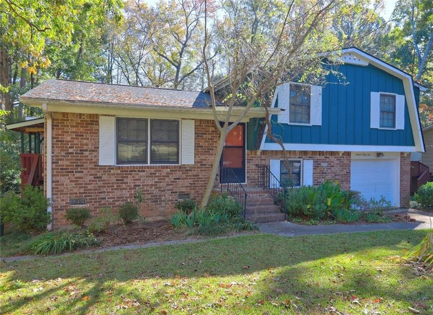 Welcome to this spacious, split-level front brick home located in a quiet and well-established Tucker neighborhood! This 3-bedroom, 1.5-bath residence sits in a peaceful neighborhood setting with the benefit of quick commutes. New roof (2024),  New AC & Furnace ( 2022), New garage door ( 2025 ),  New stove( 2025), New Dishwasher( 2025), New Range hood ( 2025),  New ceiling fans, and New fixture in the dining room. With no rental restrictions, this property is perfect for homeowners and investors alike. Don't miss out on this fantastic opportunity. Stepping inside, you are greeted with a large living room, hardwood floors throughout the main level and dining area, and an eat-in kitchen that flows out to a large deck and a large enclosed Sunroom, a level and playable backyard, ideal for entertaining and everyday living. The finished den (daylight basement ) offers additional space for a cozy family room with a fireplace and a Beautiful partial brick accent wall. It can be used as a 4th bedroom by adding a closet, or can be used as a media room, home office, gym, or guest suite-tailored to your needs. The tax records do not include the finished den, laundry room, and sunroom. With generous square footage and versatile living areas, this home is ideal for families or anyone who loves to host. The private fenced backyard and the delightful backyard are a gardener's dream and feature an oversized shed/additional storage for yard tools and more. Don't miss your chance to own this gem in the heart of Tucker. Conveniently located near major interstates, including I-285, I-85, and US-78. Just minutes from Lawrenceville Hwy, Lavista Road, and Tucker's growing downtown. With easy highway access and proximity to Shopping, restaurants, entertainment, plus Emory Hospital/CDC/VA and CHOA. This home keeps you connected to all the best Metro Atlanta has to offer.