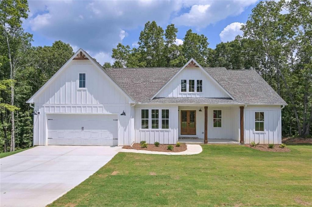 Welcome to this stunning farmhouse-style ranch home with an unfinished basement, perfectly situated on a spacious one-acre lot in the highly sought out community of The Oaks at Five Points. This beautifully designed home offers 3 bedrooms, 2 full bathrooms, and a dedicated office, making it perfect for both comfortable living and working from home. As you step inside, you'll be greeted by an open-concept layout filled with natural light and modern charm. Unique details include black interior doors and finishes, beamed ceilings in the dining room, stylish sliding barn doors, and more. The kitchen is a true showstopper, featuring a large white quartz island, ideal for entertaining or gathering with family and friends. Just off the kitchen, step onto the expansive covered back deck, complete with two sleek black ceiling fans to keep you cool during warm summer days. The private master suite is thoughtfully separated from the secondary bedrooms and includes a bathroom with dual vanities, a tiled shower with two separate showerheads, a large soaking tub, and a generously sized walk-in closet. The laundry room is conveniently located just off the master suite for added ease. The unfinished basement offers incredible potential with endless possibilities - whether you envision a home theater, gym, or additional living space. With ample storage throughout, a large backyard perfect for entertaining, and stylish features inside and out, this home blends farmhouse charm with modern convenience. This home is a MUST SEE!!