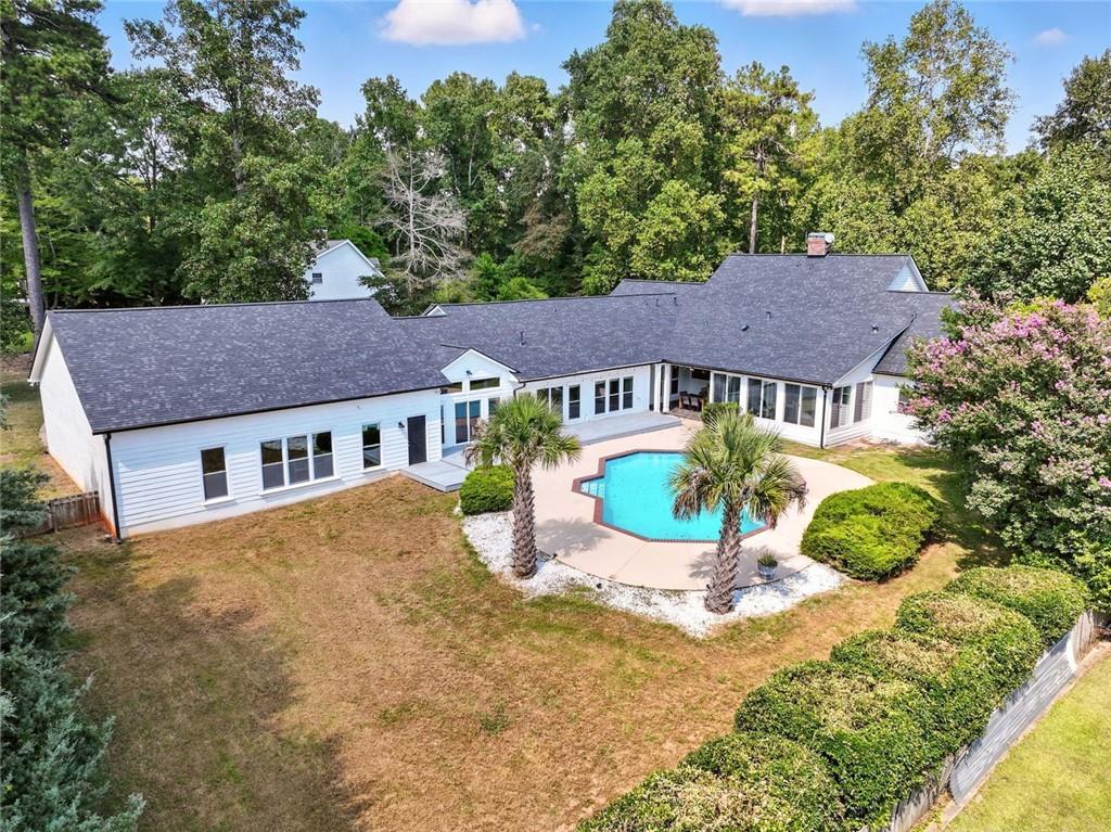 Welcome to your private retreat in the Lake Spivey community. This 4 bedroom, 4.5 bath home offers just under 4,000 square feet on more than an acre, complete with access to the community dock for boating and lake enjoyment. Recent upgrades provide peace of mind with fresh interior and exterior paint, brand new flooring, a new roof, new siding, two new HVAC systems, smart thermostats, and a security system.
Inside you’ll find a spacious layout with a large family room, formal living and dining areas, and an eat-in kitchen. A second kitchen and wet bar area create the perfect setup for entertaining. The oversized owner’s suite features a spa-like bath and a custom closet, while an additional office or optional fifth bedroom offers flexibility.
Step outside to your own resort-style backyard with a sparkling pool featuring new gunite, pump, and filter. A covered outdoor kitchen and patio provide the perfect space for gathering with family and friends. Car enthusiasts will appreciate the 8-car garage and expansive driveway with plenty of room for guests. Whether hosting by the pool or enjoying quiet mornings by the water, this home delivers the lifestyle Lake Spivey is known for.