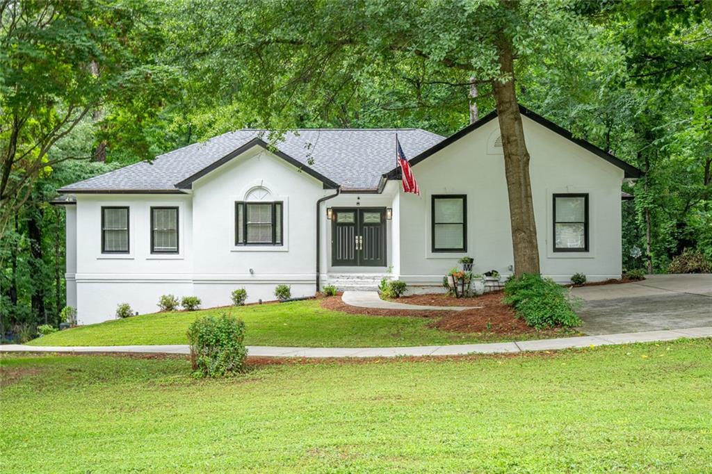 Stunning renovated Ranch with fully finished terrace level offers the perfect blend of modern luxury and functionality. In prime Brookhaven location, sited on a private, wooded lot, the home boasts expansive double decks stretching across the entire rear of the property—ideal for entertaining or relaxing while taking in the wooded natural views. Inside, the main level features a striking vaulted ceiling in the great room open to a sleek kitchen with a waterfall island, stainless steel appliances, and modern finishes. A stone fireplace adds warmth and character to the open-concept living space, all enhanced by custom accents and details throughout. The crown jewel of the four bedroom wing is the primary suite that is enhanced by a beautiful spa like bath with green wooded views. The fully finished terrace level offers a complete second living space with its own private entrance—ideal for guests, multi-generational living, or rental opportunities. It includes 2 additional bedrooms, 2 full baths, a full kitchen, laundry, hobby room and living area that leads out the its own covered deck with amazing privacy for the ultimate experience of outdoor living! Additional highlights include a 2-car garage, ample parking, and a sought-after Brookhaven address with quick access to I-285, Perimeter Business District, and Perimeter Mall. Close proximity to top-rated public and private schools, and just minutes to major medical centers including CHOA, Northside, and Emory St. Joseph’s.