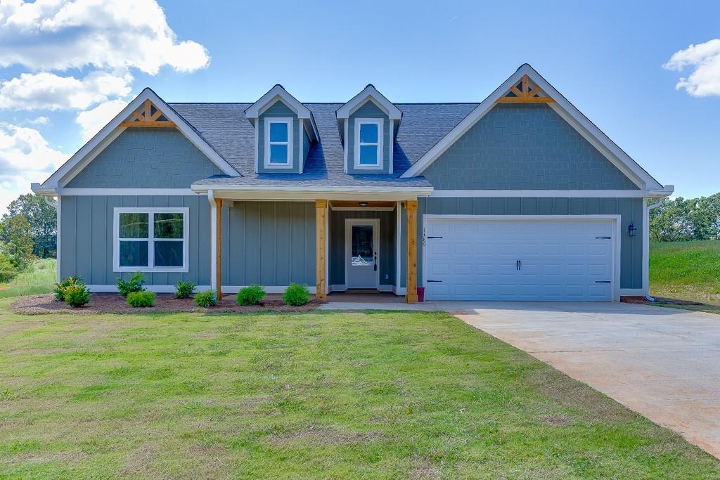 Discover unparalleled tranquility and sophisticated rural living with The Farmhouse Collection at Martin Farms - Martin, GA. This large ranch-style residence, featuring three bedrooms and two baths, is set on an expansive 1+ acre estate lot free from the constraints of any homeowners association (NO HOA!). Immerse yourself in the charm of country life with luxury amenities designed for modern comfort. The home boasts farmhouse curb appeal, waterproof LVP flooring throughout (NO CARPET), and a primary suite with a stylish oversized tiled shower for a luxurious yet contemporary feel. This well-built home also includes a covered back patio overlooking your large pasture yard, fiber cement siding, & architectural shingles. The home also boasts a well-appointed kitchen, stainless steel appliances, and white shaker cabinets. Experience the perfect blend of rural charm and refined living in this exceptional property.