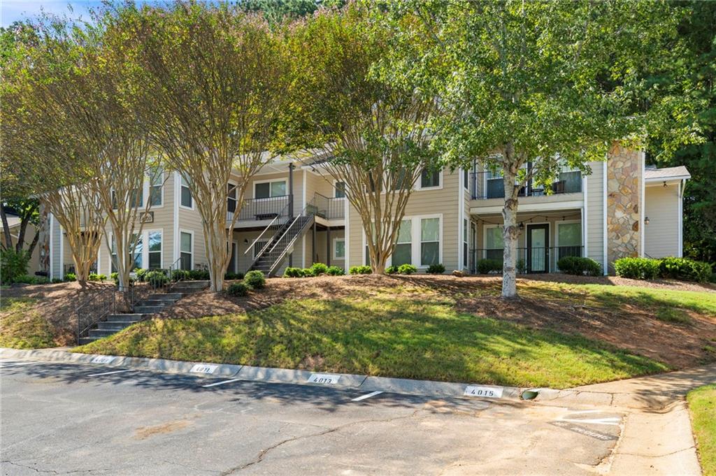 Have you been waiting for an affordable condo that offers both privacy and unbeatable convenience? Well, your patience has paid off! Welcome to this spacious 2-bedroom, 2-bathroom first-floor unit tucked away in a serene Roswell community, just minutes from everything you love about Historic Downtown Roswell and East Cobb. - The roommate-style floor plan makes daily living easy, with two generously sized bedrooms, each with large walk-in closets, separated by a bright and open living space. The living room flows naturally into a dining area and a large sunroom that doubles as the perfect flex space. Off the sunroom, a private patio extends your living outdoors and backs up to undeveloped wooded land, offering rare privacy and even the occasional deer sighting. - Inside, you’ll enjoy single-level living with vinyl flooring throughout, minimal steps to the entry, and a layout that truly lives larger than its 1,263 square feet. Priced well below recent sales in the community, this condo presents a prime opportunity to get into a desirable Roswell location at a great value. - The community itself is well maintained with a professionally managed HOA that covers water, pest control, exterior, and yard maintenance, plus a pool to enjoy in the warmer months. Neighbors here appreciate the true sense of community, quiet surroundings, and even a community lake. - The location provides for an unmatched lifestyle. Head left out of the neighborhood and you’re minutes from vibrant downtown Roswell with its incredible restaurants, breweries, festivals, and events. Go right, and you’re in East Cobb with top shopping, gyms, and dining at your fingertips. You’re also just a short drive from the Chattahoochee River and Nature Center, Azalea Park, The Mill, and miles of parks and trails. Everyday conveniences like Kroger, Starbucks, and local restaurants are right across the street. - Opportunities like this don’t last long in Roswell. Come check it out for yourself