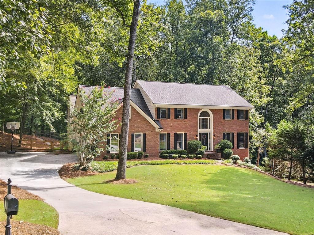 WELCOME HOME! You will love this move-in ready 5 bed, 4 bath, brick-front beauty in highly sought-after Country Club of Roswell - Willow Springs! The spacious main living level boasts a grand two-story foyer with curved stair detail, beautiful hardwood floors, and includes a formal living room— perfect for a home office or flex space, formal dining room, convenient guest bedroom and full bathroom, vaulted fireside family room with custom built-ins, wet bar, and 2nd staircase, and a heart-of-the-home kitchen, complete with stone countertops, breakfast bar, beautiful old-world style stone arch cooktop area, and adjacent breakfast area with extra storage that leads out to a cozy screened in porch overlooking the backyard! Upstairs, you’ll find thee sizable guest bedrooms, guest bathroom, and the oversized primary bedroom with enormous ensuite bath featuring a double vanity, soaking tub, large walk-in shower, and walk-in closet. The walk-out daylight terrace level includes a large finished multi-purpose space, full bathroom, and loads of unfinished storage space! Outside, you’ll find plenty of opportunity for entertaining, play, or just relaxing with a screened porch and oversized deck off of the main level, covered patio below, and green space with low-maintenance artificial turf and room for even more in the fenced-in backyard! The Country Club of Roswell (membership not included) offers tons of fabulous amenities such as a pool, golf course, tennis courts, workout facilities, bar, wine club/dinners, full dining service, and much more! Very active HOA with loads of family activities, concerts/movies at the park and more throughout the year! DON’T WAIT, be sure to schedule your showings ASAP!