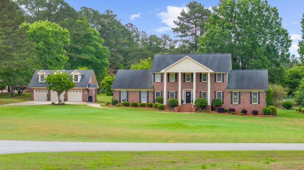 Welcome to your dream home! This beautifully maintained 4-bedroom, 3.5-bath residence sits on a spacious and level 1.3-acre lot, offering privacy, functionality, and plenty of room to entertain. Constructed with timeless four-sided brick, this home combines classic charm with modern amenities. Enjoy summer days in the backyard oasis featuring a sparkling inground pool complete with a diving board perfect for fun-filled gatherings or relaxing weekends. A detached three-car garage provides ample parking and storage, and includes a loft space above ready to finish, ideal for a home office, or studio. Inside, the home offers generous living space, including a bright and inviting layout with room for everyone. Whether you're hosting friends or enjoying a quiet evening, this home has the space and features to accommodate your lifestyle. Don't miss your opportunity to own this rare gem with room to grow, both inside and out!