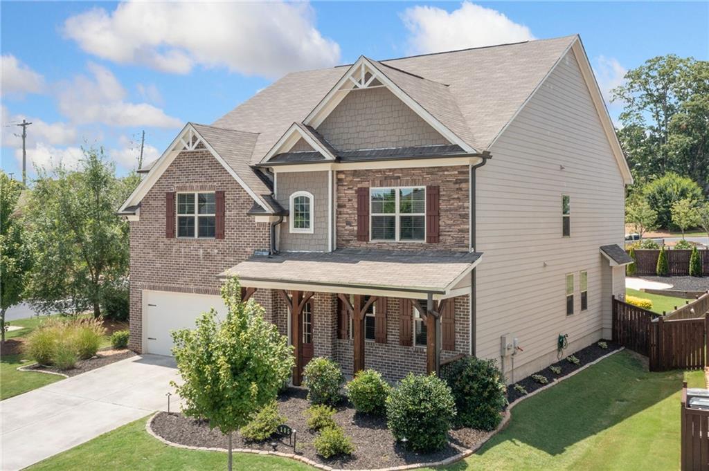 Beautifully maintained home inside and out. You will find numerous upgrades and features in this home compared to others. This is the Darlington floor plan by Lennar Homes which is very spacious and the largest in the community. Some of the features are luxury vinyl planks throughout the main level, level 2 charger for electric vehicles, screened rear porch with fireplace and TV, raised planting beds, fire pit area, grilling area next to screened porch, sand pit, large game room on second floor, 3rd full bath upstairs, upgraded appliances and more. The main floor features a private office or flex room, powder room which could be converted to a full bathroom, dining room, family room, kitchen nook, well-appointed kitchen / walk-in pantry and mud room from the garage. The upper floor features a large owner's suite / separate tub and shower / large walk-in closet / double vanity / linen closet, 3 spacious secondary bedrooms and a bonus game room or could even be a 5th bedroom. Enjoy the great outdoors on your screened rear porch with fireplace and TV. The fenced backyard is great for entertaining all ages with the fire pit area, sand box, bocce ball, grilling patio and raised garden boxes. Ideal location, which is close to 575, downtown Canton, lots of shopping around and easy access to Milton, Alpharetta, and Roswell. Award winning schools with Sequoyah High School.