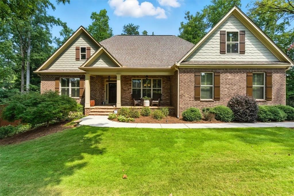 Luxury Home nestled in Hickory Flat, this home is located in Bradshaw
Glen, a private 31 home community. This home has spacious main-floor
living in addition to a finished terrace level with a full kitchen, and your own
private backyard oasis featuring a stunning saltwater pool with three
waterfall features. You’ll feel at home the moment you step inside from the
rocking chair front porch. You’ll be impressed by the spacious, open floor
plan. The sun-filled great room boasts custom built-in bookcases and a
direct-vent fireplace, seamlessly flowing into the chef’s kitchen with a large
island, perfect for entertaining or casual dining. You’ll love the abundant
counter space, plentiful cabinetry, stainless steel appliances, and a butler’s
pantry ideal for extra storage or a coffee bar. A bright breakfast nook and
formal dining room provide options for both everyday meals and family
gatherings. Extend your entertaining outdoors to the covered back deck
retreat, complete with an uncovered area perfect for grilling. This desirable
split-bedroom plan includes a private primary suite with a spa-like bath
featuring a large double vanity, tiled shower, soaking tub and oversized
walk-in closet with direct access to the laundry room. Two additional
bedrooms and a full hall bath complete the main level. Upstairs, discover
two more spacious bedrooms, a cozy sitting area, a hall bath with a double
vanity and large walk in shower and a media room (that can also be used
as a bedroom) designed for movie nights or family fun. The terrace level
offers a potential in-law suite with its own living room, full kitchen
(refrigerator, stove, dishwasher, and microwave) with a large island, dining
area, full bath with tiled shower, an office/exercise room, unfinished
storage, and a workshop with plenty of space for equipment. Step outside
to your private backyard retreat with lush landscaping and your sparkling
gunite/pebble tec saltwater pool — you may never want to leave home!
Additional highlights include a 3-car garage, excellent school district, and
convenient location close to shopping with easy access to GA400 and I575.
Don’t wait — this dream home won’t last!