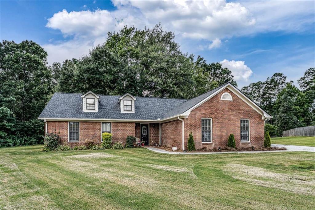 Welcome to Northwoods! This well-maintained 3-bedroom, 2-bathroom brick home features vaulted ceilings, a cozy fireplace, and a spacious kitchen that opens to the dining area. Convenient laundry access, great-sized bedrooms, and a new roof add to the appeal. Outside, enjoy a patio area, two outbuildings, and a 2-car attached garage. Don't miss this move-in ready home!