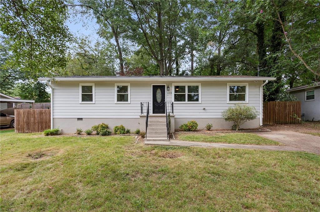 Receive up to $7,500 in closing costs or down payment assistance for qualified buyers through the Ameris Choice program.
At its core, this is not just a house—it’s a living story waiting to unfold. Set on a spacious, flat lot in a quiet East Cobb neighborhood, this 3-bedroom, 2-bath ranch home balances peace and connection in equal measure. The private, fenced backyard offers a quiet extension of the home—perfect for unwinding, enjoying fresh air, and gathering in an intimate outdoor setting.
Step into a home that breathes clarity and quiet elegance. Hardwood and ceramic tile floors flow seamlessly throughout, offering a clean, grounded foundation—every surface luminous in its simplicity, with no carpet to obscure light or collect dirt. Here, the open-concept kitchen and living room form the warm heart of the home—a place where sunlight, conversation, and comfort converge. Crisp white cabinetry and a timeless tile backsplash frame expansive counters, ready for intentional moments: morning coffee, a healthy snack, or creating meals that feed the body and soul. A brand-new stainless steel refrigerator and dishwasher bring subtle brilliance—tools of everyday life, chosen with care, ready for your story.
Beyond that lies a second, and even larger living space offering flexibility—a cozy media room, library, or game room anchored by a floor-to-ceiling wooden bookcase that stands as an architectural promise: the promise of stories, ideas, memories—and the space to curate them. This home is thoughtful in its design. The laundry/mudroom, generous and organized with built-in shelving and a private side entry, transforms routine into ritual. Step outside, and the fully fenced backyard invites unhurried moments—pets leaping, slow afternoons under dappled shade, enjoying fresh air, and gathering in an intimate outdoor setting. A spacious shed stands ready—space for tools, dreams of your backyard oasis, or echoes of what happens next.
While the neighborhood feels peaceful and tucked away, you’re only minutes from everything East Cobb and Marietta have to offer. Explore the shops and restaurants of Marietta Square, hike the trails at Kennesaw Mountain, or spend the day at nearby White Water Adventure Park. With quick access to I-75, the entire Atlanta metro is at your fingertips. This isn’t just a house. It’s a vessel of light and lineage. It invites you not just to live—but to matter here. To slow down. To gather. To mark time with intention.