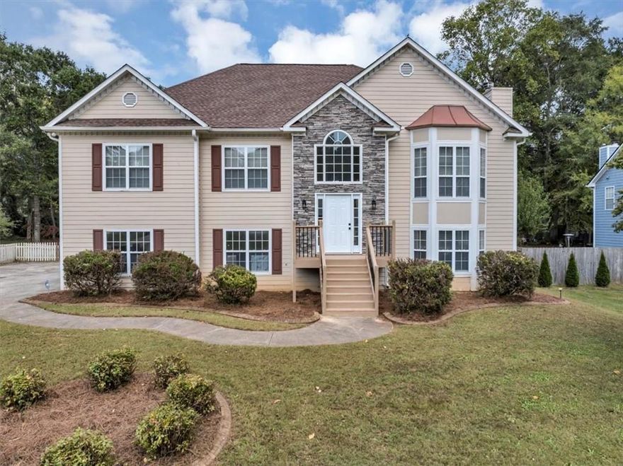 Amazing renovation located just 2.5 miles from the heart of Downtown Woodstock! From the moment you walk through the front door, you’ll be amazed by the space, natural light, and modern upgrades this home has to offer. The main level features new LVP flooring throughout (with new carpet in the bedrooms), an open and spacious family room with a stone fireplace, and a separate dining room with judges paneling. The kitchen is absolutely stunning—complete with all-new white shaker cabinets (including an island), quartz countertops, a gorgeous glass tile backsplash, stainless steel appliances, a pantry, and a bright breakfast area. The main-level guest bath has also been beautifully updated with new cabinetry, a quartz countertop, new toilet, and striking black tile flooring. All bedrooms are generous in size, especially the primary suite located at the back of the home, which boasts a tray ceiling and an incredible spa-like bath featuring modern tile flooring, a double vanity with quartz top and center tower for extra storage, a beautiful walk-in tile shower, garden tub, private water closet, new toilet, and a spacious walk-in closet. The lower level is equally impressive with an oversized second family or entertainment room, a fourth large bedroom with walk-in closet, and a third fully renovated bath showcasing new cabinetry, quartz countertop, designer tile floor, new toilet, and a Jacuzzi tub/shower combo. The laundry room is also conveniently located on this level. Additional highlights include a rare three-car garage (nearly unheard of in this price range!) and a large, level, and mostly private fenced-in backyard—perfect for outdoor entertaining. Other updates include fresh paint throughout, all new light fixtures, new door hardware, and brand-new flooring across the entire home.