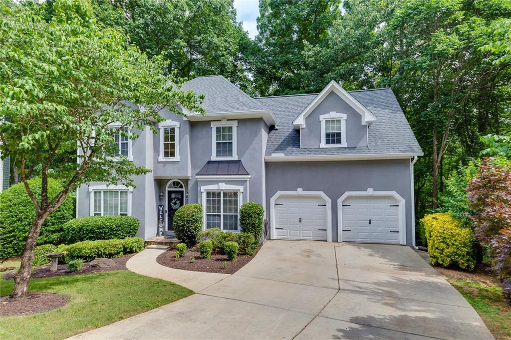 NEW LISTING!!!! MOVE IN READY!!!!! Welcome to this absolutely exquisite 5-bedroom, 3.5-bathroom home, perfectly situated on the LARGEST LOT (1.68 acres) in the sought-after Towne Lake Hills neighborhood, a premier swim and tennis community. Nestled on a peaceful cul-de-sac, this stunning residence offers an abundance of upgrades and features you'll instantly fall in love with. This beautiful home has been meticulously maintained and updated. Enjoy peace of mind with a NEW roof, NEW gutters and downspouts, NEW garage doors, freshly painted interior, freshly painted deck, newer Water Heater, and newer one HVAC. Step inside and prepare to be captivated by a two-story foyer that creates an impressive and inviting entrance. The heart of the home, the inviting family room, boasts a ** soaring vaulted ceiling** and a cozy fireplace with a gas starter (easily converted to gas logs for added convenience and ambiance). Throughout the main level, you'll discover gleaming real hardwood floors, with additional pristine hardwood flooring gracing the rest of the home, offering timeless elegance and easy maintenance. The open kitchen, boasting sleek white shaker cabinets, pristine quartz countertops, a stylish subway tile backsplash, and stainless-steel appliances, including a gas range. A light-filled breakfast area provides the perfect spot for casual dining or bird watching! Experience unparalleled outdoor living! French doors from the family room lead to a tranquil screened-in back porch that seamlessly transitions to a magnificent double-level deck. This incredible outdoor oasis offers serene, private views of the sprawling natural backyard and is absolutely perfect for grand-scale entertaining or simply unwinding amidst the peaceful sounds of nature after a long day. Imagine summer barbecues and crisp autumn evenings here! Retreat to the upstairs luxurious master suite, a true sanctuary complete with a separate sitting room for quiet moments and an additional, generous closet. The en-suite master bathroom offers a relaxing whirlpool spa tub and another spacious walk-in closet. Three additional generously sized bedrooms are also located upstairs, providing ample space and comfort for family or guests. The full finished basement adds incredible versatility and additional living space, including another comfortable bedroom, a full bathroom, a separate dedicated storage room, and its own private deck – perfect for an in-law suite, teen retreat, home office, or media room. Enjoy the ultimate convenience of living close to the popular Noonday Walking Trail, the vibrant shops, restaurants, and entertainment of Downtown Woodstock, and the recreational paradise of Lake Allatoona. This exceptional property offers the perfect blend of comfort, style, and a prime location in Woodstock, Georgia, making it a home you absolutely do not want to miss! Schedule your private showing today – this one won't last!