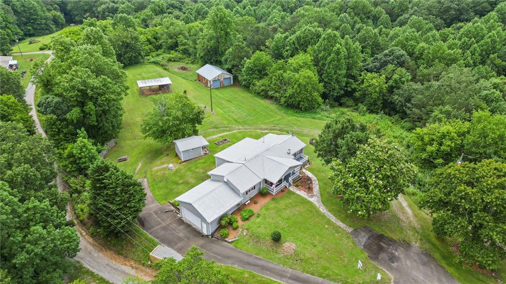 $55,000 UNDER Appraisal! Instant Equity on 6.42 Acres with Workshop & Pole Barn!
Recent independent appraisal valued this property at $495,000 — and it’s now listed for $440,000. That’s $55k in instant equity the day you close!
This 3-bedroom, 2-bath ranch sits on 6.42 private acres with no HOA and endless possibilities. A powered workshop with dual roll-up doors plus a covered pole barn make it ideal for hobbyists, contractors, RV/boat owners, or anyone needing serious storage.
Inside, you’ll find a warm and inviting layout with hardwood floors, a cozy brick fireplace with gas stove insert, and a spacious kitchen with solid wood cabinetry. Vintage touches give you the perfect base to update and make your own — without overpaying.
Enjoy mornings on the rocking-chair front porch, evenings in the screened-in back porch, and plenty of open land for gardening, animals, or outdoor fun.