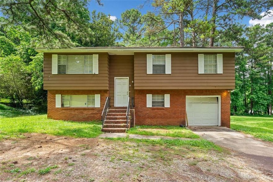 Investment Opportunity on this Riverdale Split Foyer!!  Main level open plan features a living room, dining room, tiled kitchen with separate wall oven and cooktop. Three spacious bedrooms, the full bath has direct access from the Master. Lower level has an additional bedroom, full bath, fireside den with french doors that leads to a covered patio area for additional outdoor living space, separate laundry area with additional storage space. The deck overlooks the large level backyard, a nice size front yard and 1 Car garage. This property is an excellent value for the amount of finished sq. ft. Prime location within walking distance to Community Gardens/Flat Shoals Park, close proximity to schools, shops, restaurants, amphitheater, and more. Only mins. from Hartsfield-Jackson Airport. Convenient to I-85, I-285!  NO HOA, NO SELLER DISCLOSURES, NO BLIND OFFERS.