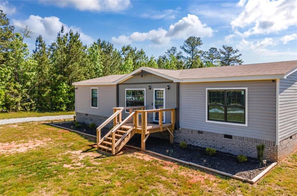 WELCOME HOME!! This beautiful brand new mobile home is situated on 4 acres of private land, offering breathtaking views and a beautiful creek. The home features a modern open floor plan with plenty of natural light and high-end finishes throughout. The spacious living room is perfect for entertaining guests or relaxing with family, and the gourmet kitchen is a dream with stainless steel appliances and plenty of cabinet space. The home has 3 bedrooms and 2 full bathrooms, including a luxurious master suite with a large walk-in closet and a spa-like ensuite bathroom. Outside, you'll find a large porch perfect for enjoying the stunning views and a spacious backyard that's perfect for outdoor activities. The property also includes a 10X20 outbuilding and plenty of space for parking additional vehicles or RVs. Located in a quiet and peaceful area, this home offers a perfect retreat from the hustle and bustle of city life while still being just a short drive away from all the amenities you need. Don't miss your chance to own this stunning property - schedule a showing today!