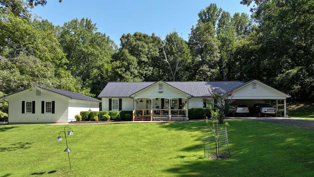 Welcome to a nature lover's retreat! This beautifully updated 3 bedroom, 2 bath home offers the perfect balance of privacy and convenience. Tucked away on a peaceful 1 acre lot, you'll enjoy the quiet and seclusion you've been looking for while still being just minutes from town, shopping, dining, and schools. Inside, you'll find a bright, split floor plan with modern finishes throughout. The updated kitchen features stylish cabinetry, a cast-iron kitchen sink, sleek countertops, and new stainless-steel appliances. The updates continue throughout the home, from new red oak flooring to even the toilets, creating the perfect setting for entertaining or relaxing. The primary suite offers comfort and privacy, while the additional bedrooms are ideal for family, guests, or a home office. Step outside to your private backyard retreat, which includes fruit trees, where you can enjoy morning coffee, evening sunsets, or weekend gatherings in a serene setting, watching the deer frolic. The fenced yard is perfect for your fur babies. The large 2-car separate garage (35x24) offers multiple possibilities, including a living space that is currently in the process of being approved by the city. The home also has new gutters with leaf guards, HVAC & ductwork, security system, coded locks, and encapsulated crawlspace. Don't miss the chance to own this move-in ready home that combines updated style, peaceful privacy, and close-to-town convenience!