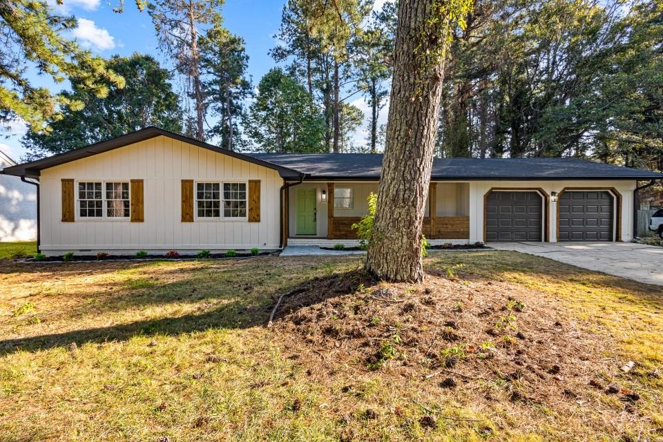 Welcome to 1396 Huntman Glen in Riverdale, Georgia - a beautifully renovated home with modern upgrades and thoughtful details throughout. Inside, you'll find a bright, open layout featuring brand-new premium laminate flooring, all-new lighting with can lights and ceiling fans, and custom touches like a hand-crafted fireplace mantle. The kitchen is a showstopper with new cabinets, stainless steel appliances, and upgraded plumbing fixtures and lines, while the bathrooms shine with custom tile showers, new vanities, and stylish fixtures. Every detail has been updated, including new door hardware, electrical outlets, and switches. The spacious main bedroom offers a special retreat with direct access to the screened back patio, perfect for enjoying morning coffee or winding down in the evening. Other updates include a brand-new roof, new garage doors, and a brand-new screened patio door, ensuring this home is truly move-in ready. Located just minutes from Hartsfield-Jackson Atlanta International Airport, and close to shopping, dining, and major highways, this home combines comfort, convenience, and quality upgrades in one package.