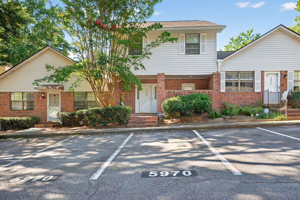 I present to you this wonderful 3BR/2.5BA townhouse located in the highly sought-after Wintergreen subdivision. This beautiful home is conveniently situated just under 2 miles from I-85 and Jimmy Carter Blvd, making it an ideal location for easy commuting and access to nearby amenities. This townhouse is one of the largest units in the community and is just steps away from the pool and dog park, perfect for relaxation and recreation. As you step inside, you'll be greeted by a spacious open floorplan featuring tile flooring throughout the main level. The kitchen is a chef's delight, boasting granite countertops, a stylish tile backsplash, and a breakfast bar that opens to the family room, creating a perfect space for entertaining. Upstairs, you'll find laminate flooring throughout, adding to the home's elegance. The oversized master bedroom is a true retreat with its huge walk-in closets, providing ample storage space. Additionally, there are two generously sized secondary bedrooms, each with large closets, and a secondary bathroom featuring granite countertops.
The charm of this home extends to the exterior as well, with a covered, rocking chair front porch that has two entrances and a garden hose connection. The gorgeous sunroom, complete with a large closet, opens out onto a beautiful brick paver patio, perfect for enjoying your morning coffee or hosting gatherings. Plus, you can enjoy a stress-free lifestyle as the exterior maintenance is covered by the HOA!!! Don't miss out on the opportunity to make this stunning townhouse your new home. Book your private showing today and experience all that this wonderful property has to offer!