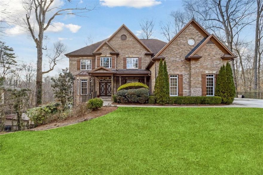 Tuscan-style dream home in McNeel Farms is a bespoke luxury residence where custom design takes center stage. Nestled on a serene, acre-sized wooded lot, this home boasts designer-inspired finishes, soaring 10-foot ceilings, and gleaming hardwood floors throughout. The gracious two-story entry Foyer is flanked by an old-world charm Study and a banquet-sized Dining Room adorned with a custom chandelier. The Great Room's focal points include floor-to-ceiling windows, a striking fireplace with a custom mantel, an antique mirror, built-in bookcases, and an impressive 20-foot coffered ceiling complemented by a magnificent chandelier. The eat-in Kitchen is a chef's delight, featuring Viking appliances, custom cabinetry, exquisite millwork, and bricked flooring that enhances its sophisticated character. The space also includes a professional-grade gas range, a Sub-Zero glass-front refrigerator, a wine fridge, stone countertops, designer fixtures, and a coveted walk-in Pantry providing ample storage. Adjacent to the Kitchen, the cozy Keeping Room features a fireplace, custom built-in bookcases, and access to an enclosed Porch and Deck. The light-filled main-floor En suite Bedroom doubles as a Home Office space and offers serene views of the rear deck and backyard. Upstairs, the elegant Primary Bedroom Suite features a gas fireplace and a luxurious Bath with custom vanities, an oversized Jacuzzi soaking tub, a separate dual walk-in shower, and a spacious walk-in Closet. Three additional Secondary Bedrooms include one En suite and two connected by a Jack-and-Jill bath, each outfitted with a Jacuzzi tub/shower, custom cabinetry, designer fixtures, and ample closet space.
The Laundry Room is thoughtfully designed with a wet sink and custom cabinetry. The two Daylight Lower Levels, complete with full decks, provide an opportunity for customization to suit your needs. This one-of-a-kind luxury residence is located within the award-winning Hillgrove School District and is just two miles from Cheatham Hill Battleground Park and its scenic trails. A unique opportunity not to be missed offered by a very motivated seller!