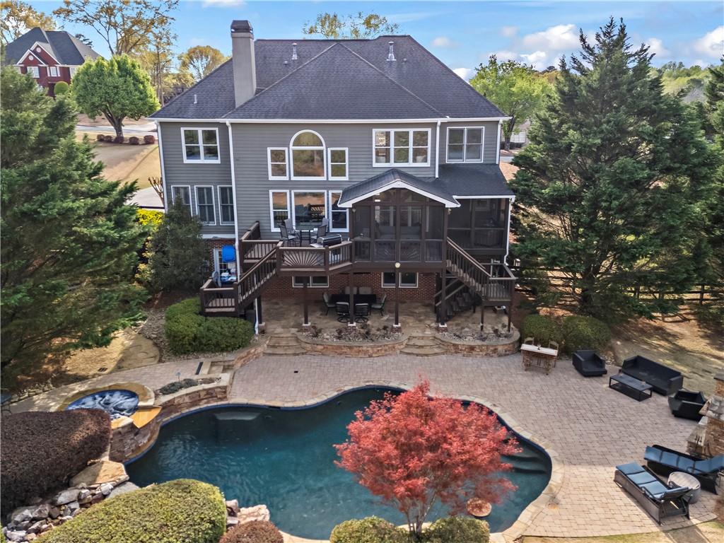 Welcome to 410 Hickory Fairway Ct, a stunning home in the highly sought-after Bradshaw Farm community. Perfectly situated on a cul-de-sac lot with breathtaking fairway views, this home offers luxury, comfort, and unbeatable outdoor living. The backyard is an entertainer’s dream with a custom pool and spa, a screened-in porch, and an outdoor fireplace, all surrounded by professional landscaping. Inside, the enormous vaulted primary suite feels like a retreat, featuring a spa-like bathroom with marble wall tile, a freestanding tub with a tub filler, a custom glass shower, and brand-new vanities, countertops, mirrors, and lighting. The gourmet kitchen boasts a brand-new Bosch five-burner gas stove, sleek new countertops, and a designer backsplash. Flex room on main that can serve as an office, bedroom, playroom, etc. A fully finished basement with an in-law suite provides extra space for guests or additional living areas. Throughout the home, you'll find new closet shelving, upgraded outlets, and fresh hardware, blending modern updates with classic charm. Located in a top-rated school district with access to golf, swimming, and tennis amenities, this home offers an incredible lifestyle in one of Woodstock’s most desirable neighborhoods. Don’t miss the chance to make it yours. Showings will begin Sat, 4/12. Preferred lender incentives available!