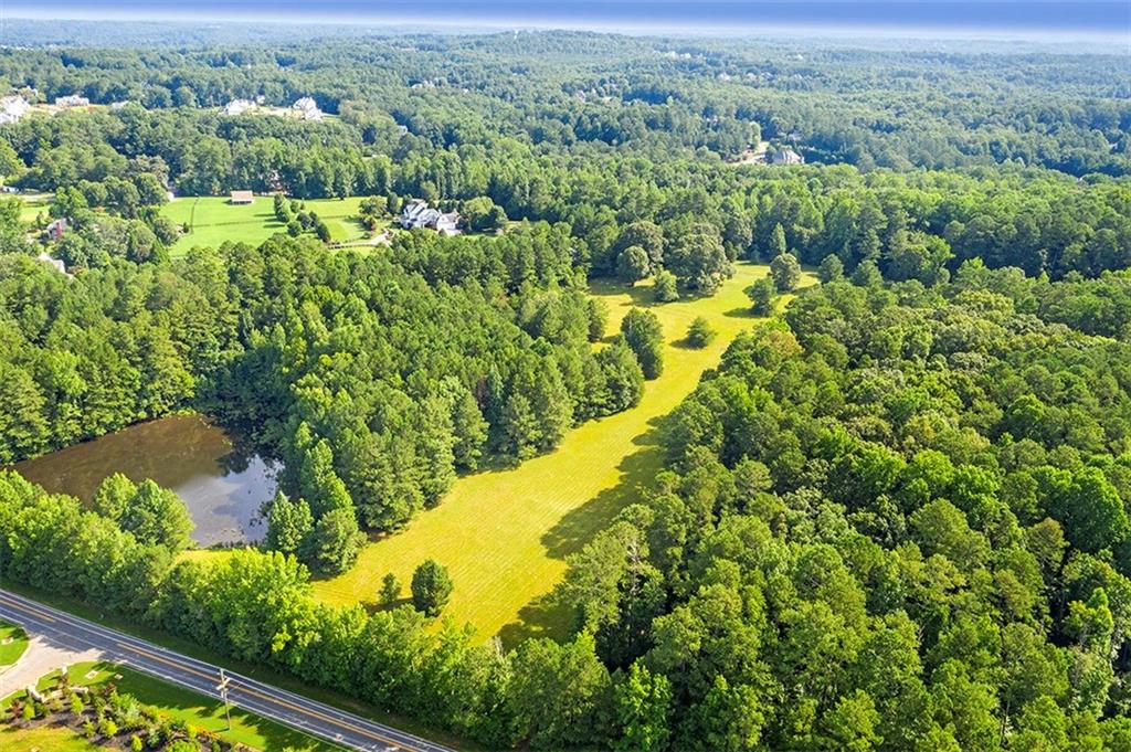 Attention Developers, Investors, and Buyers! Outstanding Opportunity to develop or make this your own paradise! Prestige 50.09 acres (2 adjoin parcels) located in prestigious Milton/Alpharetta, Georgia. This property is located amongst equestrian farms, facilities, and multi million dollar properties. One of the last offerings of this size in this area- and one of the best you can imagine. Property offers a 1.8 acre pond which is fed by a drilled well. The access to the cleared area is from Freemanville Road. Make it your epic estate site or developers may choose to build million dollar + homes on gentle rolling homesites. Property would be highly suitable for an equestrian facility. Bring your dream and make it a reality. Just a very short distance to downtown Alpharetta where you will find upscale shopping, fine dining, casual restaurants, and numerous activities. Easy access to GA-400 without a hassle or sound of traffic. Don't miss making your appointment to see this fabulous property before it is not available. No surprises here! This is beautiful property.