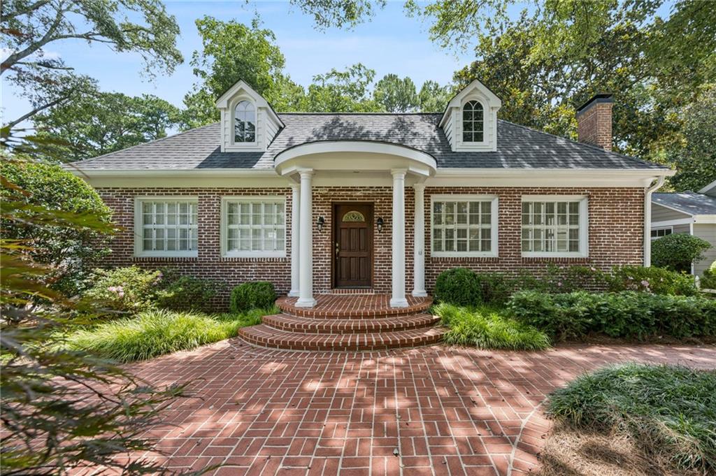 Collier Hills picturesque brick traditional for lease. Very large 3 bedroom home near Tanyard Creek Park. Classic columns frame the front door and lush established landscaping surrounds the home. Entry foyer opens to formal fireside living room and dining area. Lovely kitchen with freshly painted cabinets, granite counter tops and stainless steel appliances with breakfast nook. Den just off the kitchen with views to back deck. Large primary on the main level with entry bookshelves, 3 large closets, and Juliette balcony overlooking private back yard. Large laundry room on this level with 2 additional spacious bedrooms and hall bath. Lower level has 2 story family room perfect for movie nights or playroom area. 2 car garage and plentiful driveway and parking pad.