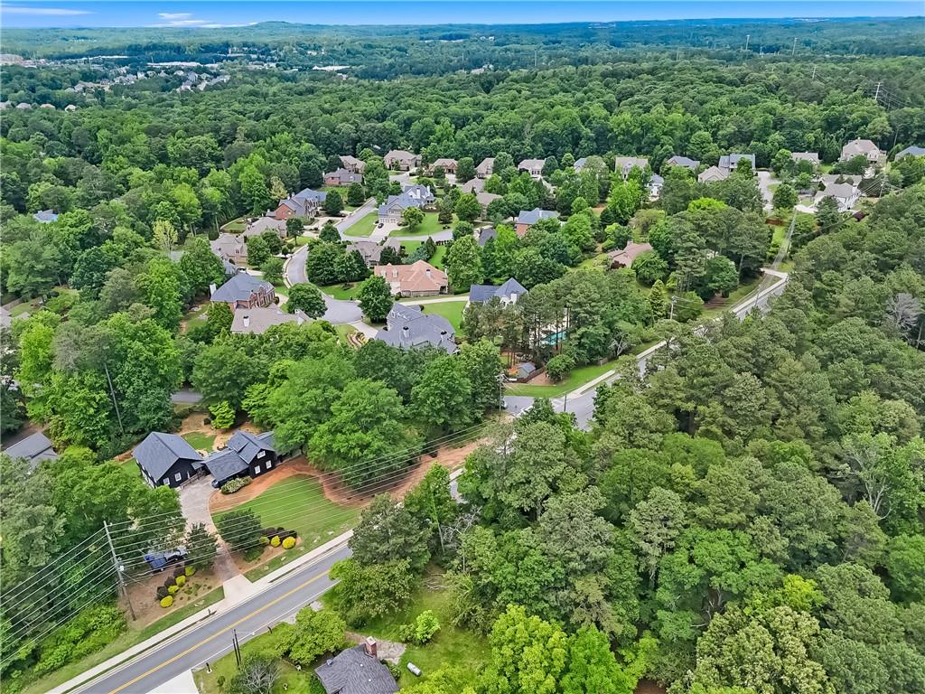 Exceptional Location with Endless Potential on a Spacious Private Lot Discover the possibilities with this rare opportunity in highly sought-after Marietta. Tucked away on an oversized, private lot, this property offers peace and privacy just minutes from top-rated schools, Marietta Square, and an array of local amenities. Set back from the road, the expansive and level grounds provide the perfect canvas for your vision. The existing home is in need of major repairs and is being sold as-is-ideal for a full renovation, addition, or complete rebuild to create your dream home. With no HOA restrictions, there's ample room to design your own retreat-whether that includes a pool, garden, or custom outdoor living spaces. Surrounded by beautiful homes in a prime location, this property is brimming with potential. Don't miss your chance to turn this unique lot into something truly special!