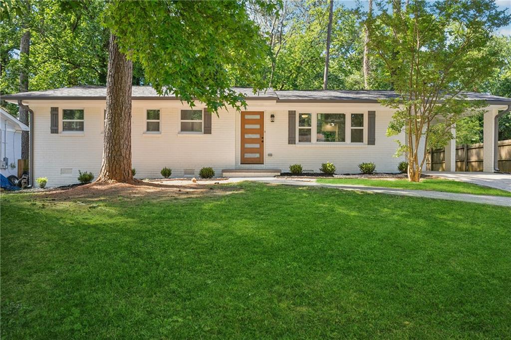 Welcome to this gorgeous totally renovated, 4-sided brick home. It has been completely updated featuring a stunning, modern kitchen with quartz countertops, custom designed cabinetry and all new appliances. A large laundry room sits right off the kitchen. With two entry ways, this space could also be used as a utility room or a mud room. The living room and dining room areas have been converted to feature an open concept floor plan with recessed lights, ceiling fans and hardwood floors throughout the entire home. As you walk down the hallway, you step into the first renovated bathroom with a custom vanity, quartz countertop and a beautifully designed shower and tub combination with elegant tile covering the floor and walls. This home also offers a Luxurious Master bedroom which has a spacious layout with a beautifully designed en-suite with a custom vanity, quartz countertop and a gorgeous shower with elegant tile that covers the floor and walls. Every detail of this home has been addressed. It has a new roof; new paint inside and outside, new plumbing and all new windows. New insulation has been added to the attic to make the home more energy efficient. The electrical panel is new and the HVAC system has been recently serviced and is very well maintained. As you step outside through the new patio door to a large, spacious backyard, there is a welcoming patio that sets the stage for summer barbecues, playful afternoons, or quiet evenings under the stars. Perfectly positioned with easy access to downtown Atlanta, I-20, and I-285, this home keeps you connected while offering proximity to local parks, shopping and restaurants. This home is move in ready!!