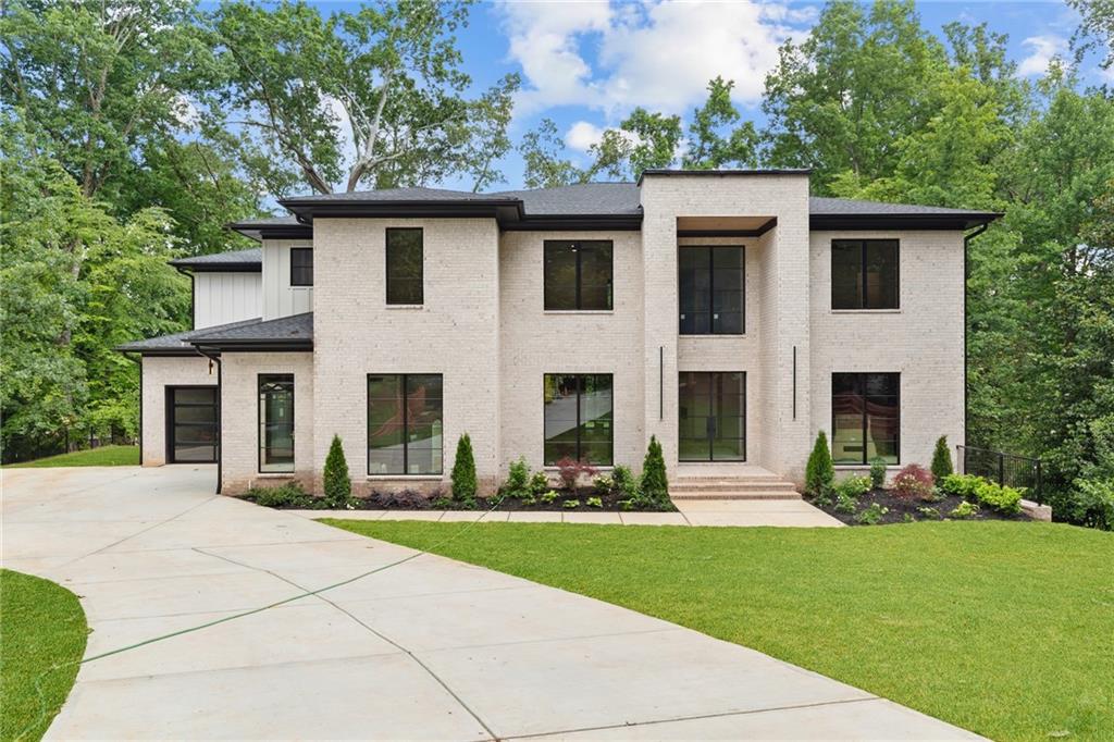 Welcome to a timeless new construction home in the heart of Brookhaven—where elegance meets functionality. Set on a large landscaped lot with a 3-car garage and an unfinished basement ready for future customization, this 5-bedroom, 5.5-bath residence is flooded with natural light and thoughtfully crafted details. Step inside to a grand foyer that leads to a private study and an expansive dining room that comfortably seats 12+. The main level also features a guest suite with a full bath, a separate powder room, and a custom mudroom. The heart of the home is a designer kitchen outfitted with top-of-the-line appliances, a sunny breakfast room, and a hidden scullery—perfect for entertaining. The kitchen flows seamlessly into the inviting family room with a cozy fireplace and backyard views. Upstairs, a spacious media room with trey ceilings offers endless possibilities. The oversized owner’s suite is a luxurious haven with a private sitting area, his and hers walk-in closets, and a spa-inspired bath complete with double vanities, a soaking tub under skylights, and a separate glass shower. Three additional ensuite bedrooms and an upstairs laundry room complete the upper level. Enjoy peaceful mornings and cozy evenings on the covered patio with a walk out backyard and outdoor fireplace—ideal for future pool! Located minutes from top-rated schools, shopping, dining, parks, and major highways, this exquisite Brookhaven home offers sophisticated living in an unbeatable location. POOL PERMIT AVAILABLE!!