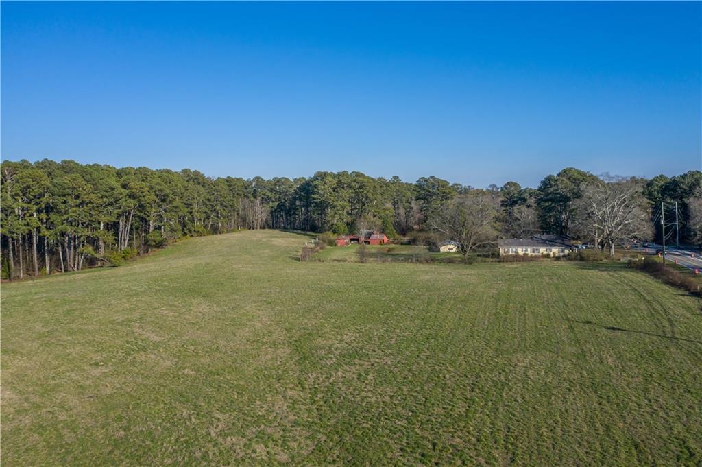 One of the last tracts of raw land in the Milton High School footprint. Approx 34 acres of beautiful land perfect for an executive retreat with a caretaker home in the existing 1930s bungalow.Or develop as a subdivision of luxury homes in the City of Milton. Operated as a farm since 1953 by the JL English family.Now Estate and family owned.Open pasture land plus partially wooded tract with mixed pine, hardwoods. Property is fenced and surveyed.New roundabout being built at corner of Mayfield Rd. Bethany Rd abuts the property.Sewer in the street on Mayfield Rd.Zoned AG1. First time on the Market. This approx 34-acre farm was purchased by JL English in 1953.Mr. English raised corn, hay, black Angus beef cattle and prize-winning tomatoes. Helen C English died in April 2019 at 94 years of age and the farm is now held in her estate. Rolling green pastures face Mayfield Road and flank the existing white farmhouse which has long been a landmark in Alpharetta, North Fulton and now the City of Milton.Mature water oaks in the front yard define the home.One of the first things Mr English did was drill a well which produces noticeably sweet spring water. The original barn standing beside the home was torn down by Mr. English when he moved a much older and larger barn from a farm closer to Crabapple to the property in the 1950s. A blacksmith shop was moved to the property at the same time.A chicken house was built later in the 1950s but this business was abandoned. A tractor shed was built by Mr English in the 1960s.Mr. English raised cattle up until the time of his death at 98 years old.This is a once in a lifetime opportunity to secure a fabulous location in between downtown Alpharetta and Crabapple. Milton High School is just around the corner.