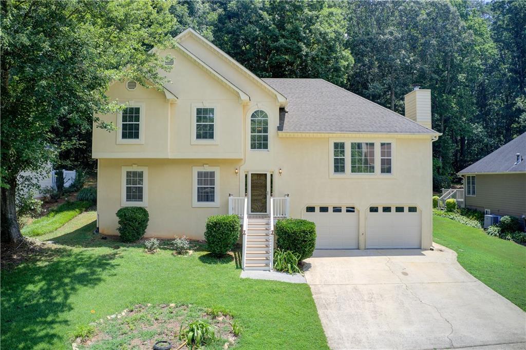 Welcome to Your Dream Home! This beautiful property truly has everything you've been looking for-comfort, space, and an unbeatable location just minutes from Bells ferry Rd, I 575, I-75 and charming downtown Woodstock. The main level features a spacious open floor plan filled with natural light and highlighted by a cozy fireplace. The expansive dining room flows into a beautifully renovated kitchen with granite countertops, ample cabinetry and an eat-in area that open directly to serene patio. The oversized primary suite offers a large walk-in closet and luxurious full bath with double granite vanity. Upstairs you'll find two additional generously sized bedrooms and full bath. One of the standout features of this home is the fully finished in-law suite, complete with a full kitchen, full bath and private access from the backyard. Don't miss this rare opportunity to own a move-in ready home in prime location!