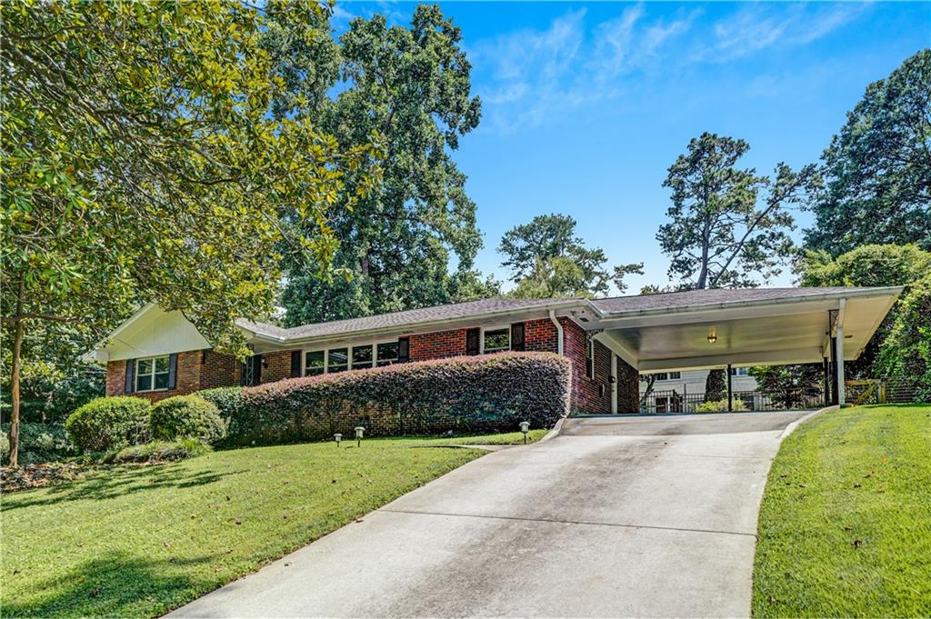 Welcome to 2127 Desmond Drive, a beautifully updated rental home located on a spacious corner lot in one of Decatur’s most beloved neighborhoods—Clairmont Heights/Medlock Park. Just steps from South Peachtree Creek Trail, Medlock Park, and Emory’s Clairmont Campus, this prime location offers unbeatable access to green space, recreation, and convenience. Only 5-minutes from Downtown Decatur, Emory Village, and Toco Hills, giving you quick access to top dining, shopping, and entertainment options, as well as renowned schools and hospitals. Inside, this home offers modern comfort and flexibility with three spacious bedrooms, two fully renovated bathrooms, two separate living rooms, a dedicated dining room, and a home gym. The kitchen is outfitted with brand new stainless steel LG appliances, white cabinets, and granite countertops making it both stylish and functional. Step outside to enjoy a fully fenced backyard, professionally landscaped front, side, and rear yards, and a stone patio perfect for entertaining or relaxing evenings. The two-car covered carport includes a Tesla charger for added convenience. The home is Pet-friendly, beautifully maintained, and move-in ready. Laundry (washer and dryer) are located in the basement next to the home gym. Enjoy year-round baseball leagues, a community pool, state of the art nature trails and a brand new playground—all within walking distance at Medlock Park. Schedule your showing today. This home will not last long!
