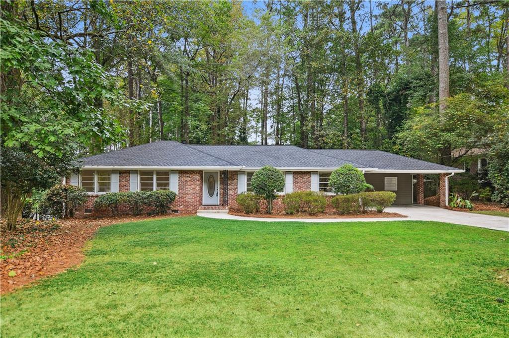 Charming Updated Ranch in a Peaceful, Walkable Neighborhood! Welcome to this beautifully maintained ranch-style home that exudes classic charm and modern updates. Nestled on a quiet, tree-lined street in a highly desirable neighborhood, this 3-bedroom, 2-bathroom gem offers the perfect blend of comfort, style, and convenience. Step inside to discover fresh interior paint and stunning luxury vinyl plank flooring throughout. The renovated kitchen is a true showstopper, featuring new stainless-steel appliances, granite countertops, and crisp white cabinetry—ideal for cooking and entertaining. Open to the kitchen is a cozy family room featuring a convenient electric fireplace and views to the large, fenced backyard. Both bathrooms retain their charming original tile, offering a touch of vintage character. Major systems have all been updated for peace of mind, including a new roof, new HVAC, and new water heater. Out back, you'll find a spacious, two-story insulated storage building with electricity—perfect for a workshop, art studio, home office, or simply extra storage space. Located in a friendly community where neighbors regularly stroll with their dogs, this home is just minutes from Northlake’s best shopping, dining, and amenities. Don’t miss your chance to own this move-in-ready home in an unbeatable location!