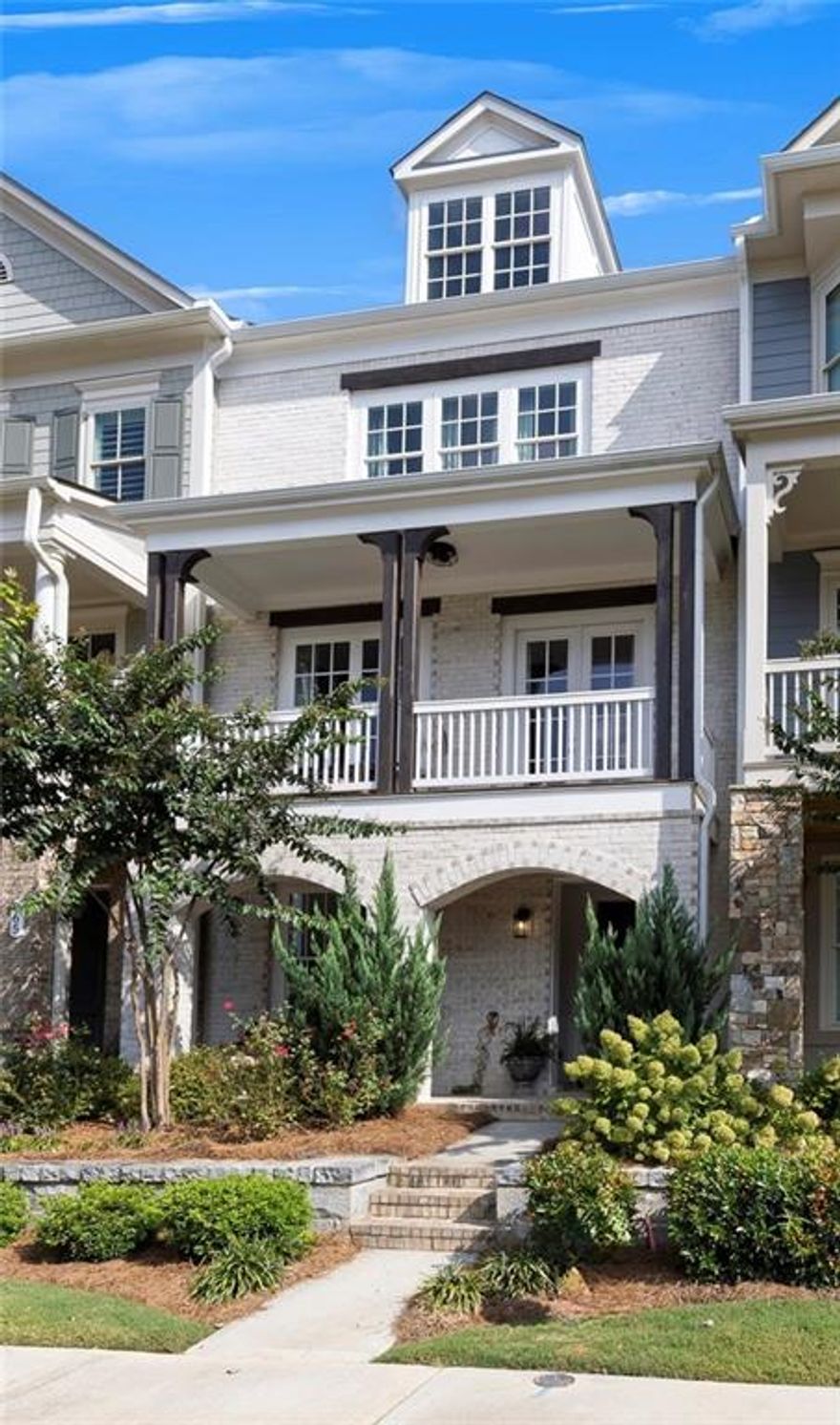 Stunning townhome located in the highly sought-after South on Main community in the heart of Downtown Woodstock. This popular Andrews floorplan offers three levels of beautifully designed living space. The entry level welcomes you with an inviting foyer that leads to a private bedroom with a charming barn door and full bath—perfect for guests or a quiet home office. The rear-entry two-car garage opens into a convenient drop zone for everyday ease. The main level is filled with natural light and features a spacious family room with a cozy fireplace, built-in shelving, and access to a front balcony—an ideal spot for your morning coffee. The open layout flows seamlessly into the dining room, creating the perfect setting for entertaining. At the heart of the home is a chef’s kitchen complete with floor-to-ceiling white cabinetry, a large center island with seating, and a breakfast area with access to the rear deck for grilling. A keeping room with beamed ceilings provides a warm and relaxing retreat, while a guest powder room completes this level. Upstairs, the owner’s suite is a private retreat with a large walk-in closet and a luxurious spa bath featuring double vanities, a soaking tub, and an oversized walk-in shower. A spacious secondary bedroom with a private ensuite bath and a laundry room with cabinets and sink provide both comfort and convenience. This home is elevator-ready, with the shaft offering the flexibility to install an elevator in the future or enjoy the impressive additional space as extra storage or a functional office nook. Life at South on Main is truly exceptional. This premier community spans 20 acres of green space and parks, offering a community garden, firepit, resort-style swimming pool with splash pad and cabana, and a 6,000-square-foot clubhouse with fitness center, game room, and conference space. Residents also enjoy two dog parks, a play park, an open-air pavilion, “The SHED” stage for live events, and direct access to the Noonday Creek Trail, part of the expansive Greenprints system. All of this is just steps from the vibrant energy of Downtown Woodstock and minutes from I-575, making for an easy commute to Atlanta and beyond. Experience why South on Main and Woodstock are among North Georgia’s most sought-after destinations—this home offers the perfect blend of style, comfort, and lifestyle.