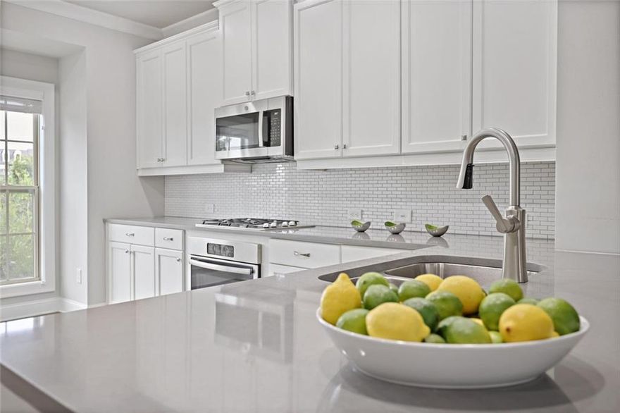 Experience turnkey luxury just minutes from the vibrance of Downtown Roswell's Canton Street. Brimming with natural light across all three levels, this stunning Roswell townhome blends sophisticated upgrades with a flexible and functional layout. Located just perfectly between Alpharetta and Roswell among top-rated Fulton County schools, and within easy reach of John's Creek, the home offers both elegance and convenience.  Upon entering from the garage, a versatile full en suite bedroom awaits—ideal as a private guest retreat, home office, or fitness space. Experience the main level through the charming front entry as it unfolds into a sunlit, open-concept living and dining area. The showpiece kitchen boasts pristine white cabinetry, soft grey stone countertops, and a seamless flow perfect for both everyday living and hosting friends. An additional office alcove or reading nook overlooks the inviting deck. A striking stone-accented fireplace is framed by custom built-ins topped with sleek granite, creating an exciting focal point that instantly elevates the home’s entertainment space. Upstairs, a convenient laundry room and two spacious bedrooms with bathrooms await, including the luxurious primary suite with a spa-inspired bathroom and a meticulously organized walk-in closet.  Enjoy the neighborhood’s best location—front-facing, unobstructed views, and direct access to generous guest parking. Offered with the option to include furnishings for a truly move-in-ready experience, this exquisite townhome is not to be missed!
***This property qualifies for the Community Lending Program, offering LOWER RATES and closing cost incentives!***