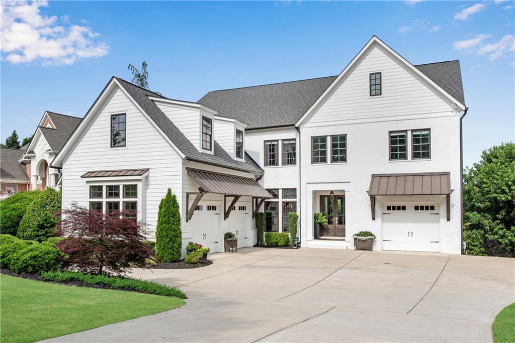 STUNNING “LIKE NEW” CUSTOM HOME built in 2019 in sought after DENMARK HIGH SCHOOL district! This MODERN STYLE FARMHOUSE is well-appointed and resplendent in beautiful moldings & architectural details. Beautiful french doors welcome you into a 2-story foyer providing the first glimpse of the luxurious features throughout this home. The FAMILY ROOM has a stunning wall of windows, working fireplace with CUSTOM TILE SURROUND, WOOD BEAMS, custom cabinets & FLOATING SHELVES. The CHEF'S KITCHEN boasts quartz counters, FARM HOUSE SINK, BUILT-IN REFRIGERATOR, GAS RANGE, double ovens, microwave, BEVERAGE CENTER, walk-in pantry, a FABULOUS ISLAND and separate breakfast room. STACKING NANO DOORS open to the COVERED REAR PORCH which is the perfect spot to sit by the fire and enjoy the private back yard.  Don’t miss the guest bedroom with en-suite bathroom, the office and a SEPARATE POWDER BATH that complete the main floor. The MASTER SUITE offers a double tray ceiling, SPA STYLE BATHROOM with SOAKING TUB, a CUSTOM CLOSET, reading nook and easy access storage area. The upstairs secondary bedrooms are HUGE and all have en-suite bathrooms & large closets. Wait! There is more! A FINISHED TERRACE LEVEL offers a CUSTOM BAR, family room, BEDROOM, FULL BATH, media room, pool table area & more! The private back yard is very deep - check out the aerial view – and ready for a pool!!  Did I mention the house is WIRED FOR SPEAKERS in several locations, has 10 FOOT CEILINGS & 8 FOOT DOORS on the main floor and in the basement, has a HOT TUB that stays, a 4th GARAGE located in the terrace level for extra storage & an EXTRA PARKING PAD - perfect for a family with teenagers!  Stoney Point Farms is a GATED, Swim/Tennis Community that is 3 miles from Halcyon, 7 miles from Avalon/Downtown Alpharetta and only 4 miles from The Gathering – Forsyth County’s future sports arena, shopping, dining & entertainment complex!