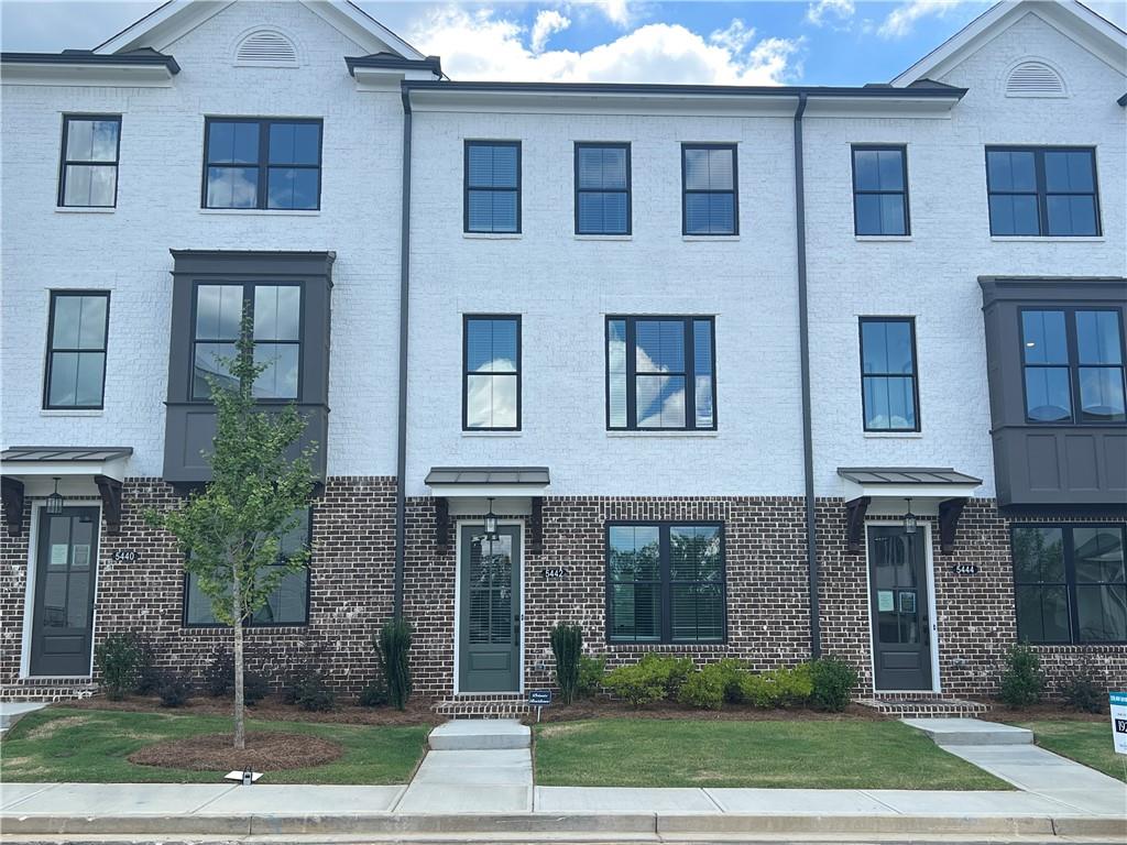 Brand New Luxury Townhome in Gated Buford Community – Just 5 Minutes from Suwanee Town Center!
This stunning 2024-built, 3-story townhome by The Providence Group features the spacious Glendale floor plan, offering modern elegance, thoughtful design, and unbeatable location.
The main level showcases a bright, open layout with a sunroom/flex space—perfect for a home office or breakfast room. The chef’s kitchen includes quartz countertops, stainless steel appliances, tile backsplash, a kitchen island with breakfast bar, and even a kitchen window for extra charm. Flowing seamlessly into the dining and family room, this space is ideal for entertaining.
Upstairs, enjoy a luxurious owner’s suite with vaulted ceilings, an oversized walk-in closet, and a spa-like bath with frameless glass shower, soaking tub, and dual vanities. Each secondary bedroom includes a private en-suite bath, and laundry is conveniently located upstairs. The terrace level offers a private guest suite or home office—perfect for multi-generational living or visiting guests.
Other features include a 2-car rear-entry garage, garage door openers, and ample storage.
Enjoy resort-style amenities: gated entrance, clubhouse, fitness center, resort-style pool with cabana and grill station, outdoor fireplace, dining areas, and a central green space with Adirondack chairs and fire pits.
Conveniently located near Sugar Hill, Suwanee Town Center, and Downtown Buford, with easy access to I-985, shopping, restaurants, and parks. Top-rated Gwinnett County schools complete the package—this is low-maintenance luxury living at its finest!