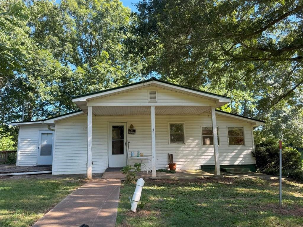 PRICE REDUCED BY $50k on this Fixer-Upper Opportunity! Whether you're looking to expand your rental portfolio, looking for a rehab project to make this your personal home, this versatile property offers endless possibilities! This home currently has a Nice Sized Living Rm, 2 Bedrooms and has two (2) Full Tiled Bathrooms one with a walk-in Tub for Handicap Access, Kitchen accessible from Living Room and Master Bedroom. Partial Unfinished Basement. With over an acre and Half of land with lots of beautiful trees, shrubs, and landscaping, there’s plenty of space to garden, play, or expand and make this home for your vision. Parking Shed and Plenty of Parking Space. Opportunities at this price point are rare in today’s market, so don’t miss your chance! Schedule your private showing today and explore the potential of this unique space! Near Northeast Georgia Hospital, Quick and easy access to Downtown Gainesville, Hwy 985, Hwy 129, and Hwy 365.