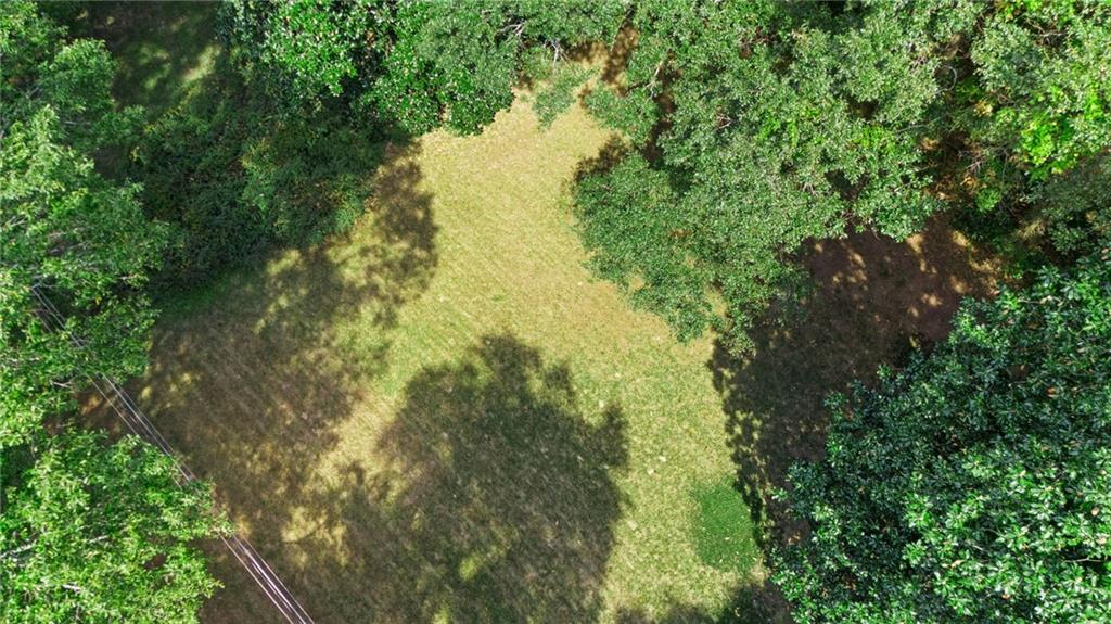 Owner Financing Available! Flexible terms with low down payment and affordable monthly payments—no banks or credit checks required, making this the perfect opportunity for builders, investors, or future homeowners. This 0.43-acre build-ready lot in booming Historic Downtown Lithonia is flat, usable, and already 60% cleared, with all utilities available at the street (sewer, water, electricity, and gas) to save you time and thousands in prep work. Zoned residential and surrounded by new construction homes and townhomes selling between $325K–$400K, this property offers exceptional potential in a rising market. Located on a quiet street for added privacy yet just minutes from shopping, dining, Stonecrest Mall, and major highways, it provides the ideal mix of seclusion and convenience. With no HOA fees, builder-friendly permitting, and long-term growth potential, this is one of Metro Atlanta’s rare lots offering both affordability and flexibility. Don’t miss your chance to be part of Lithonia’s exciting transformation—schedule your visit today!