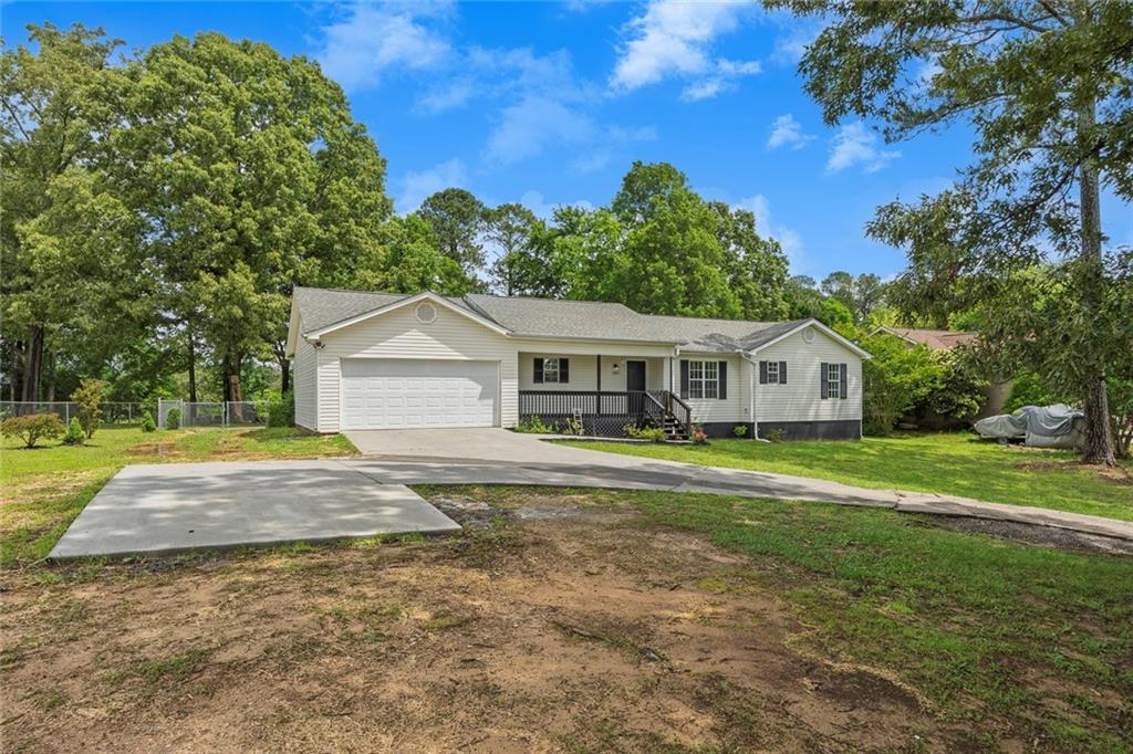 Beautifully maintained ranch-style home nestled on a spacious lot in the heart of Chatsworth. Enjoy peaceful mornings or relaxing evenings on the classic rocking chair front porch. Step inside to discover a warm and inviting floorplan featuring durable, easy-to-maintain LVP flooring throughout. The cozy living room centers around a gas log fireplace, perfect for gathering on cool evenings. A separate dining room provides a great space for entertaining, while the large kitchen boasts white cabinetry, stainless steel appliances, and ample counter space ideal for meal prep and family cooking. The generously sized primary bedroom offers a walk-in closet and a private en-suite bathroom complete with a separate soaking tub—your own personal retreat. Two additional bedrooms offer comfort and flexibility for guests, a home office, or hobbies. Step outside to a large, fenced backyard complete with a covered patio and an above-ground pool, perfect for enjoying warm summer days with family and friends. Located in picturesque Chatsworth at the base of Fort Mountain, this home offers easy access to the best of North Georgia living. Explore the rich history, local dining, cultural events, and the endless outdoor adventures available at nearby Fort Mountain State Park and the Cohutta Wilderness, offering over 90 miles of scenic trails. For race enthusiasts, the North Georgia Speedway is just a short drive away. Don't miss this opportunity to enjoy peaceful living with modern comforts in a vibrant, adventure-rich community. **USDA ELIGIBLE**