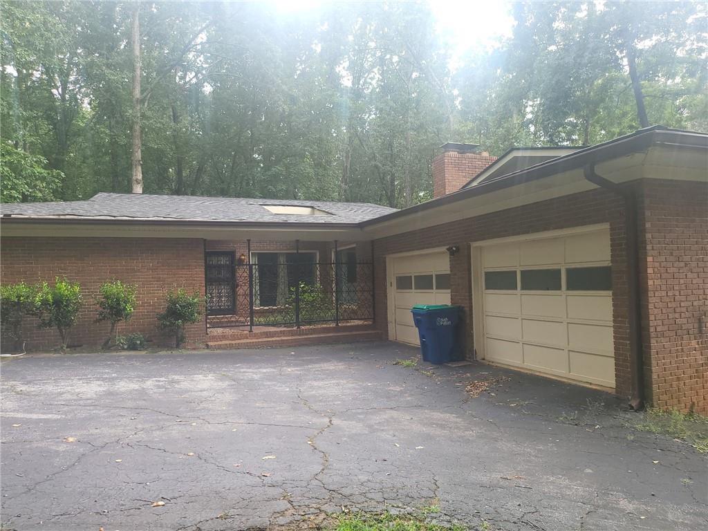 Welcome to this 3-bedroom, 3-bathroom ranch style brick home on a finished basement. The property is nestled on an unusually generous 1.81-acre lot tucked away in the City Of South Fulton. A functional flow from living areas to kitchen and bedrooms, ideal for both family life and entertaining. Spacious bedrooms and well-appointed bathrooms - ready for updates or leaving as-is for charm and value. This property offers a wooded lot offering privacy, space for recreation, and potential for garden or outdoor living enhancement. This home presents excellent potential for value-driven buyers and investors alike, offering a canvas to modernize or furnish as a turnkey option in a desirable, well-established neighborhood close to Interstate 285 Interstate 85 and Atlanta's Hartsfield International Airport.