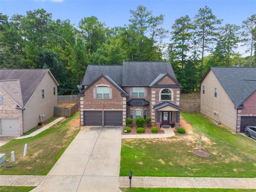 Discover comfort and elegance in this beautifully maintained home in Patriot's Pointe! Start your mornings or wind down your evenings in the peaceful, level backyard lined with trees and complete with a private patio, perfect for entertaining or relaxing. Inside, the heart of the home is the open-concept kitchen, featuring granite countertops, stainless steel appliances, and a center island, seamlessly connected to a cozy fireside family room ideal for gatherings. On the main level, you'll also find a formal dining room with coffered ceilings, perfectly set for special occasions, and a welcoming two-story foyer that makes a bold first impression. Upstairs, retreat to the oversized owner's suite, complete with a vaulted ceiling, generous walk-in closet, and a luxurious private bath that offers a spa-like experience. With 5 spacious bedrooms and 3 full bathrooms, there's plenty of room to grow, host, or create your ideal work-from-home setup. Whether you're looking for a primary residence or an investment opportunity, this home offers flexibility.