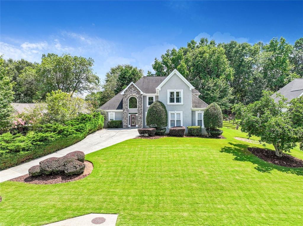 MASTER ON MAIN in sought after Bradshaw Farm Swim/Tennis/Golf Community. Level, fenced, .56 acre lot. Open floorplan well suited for single level living with a large kitchen open to a vaulted keeping room. Spacious family room with easy access to the screened porch and the wood burning fireplace and patio with hottub! 3rd car garage, located at basement level, offers it's own driveway and allows for mutli family living or just more garage space. The finished basement offers a huge family room, game room, bedroom, office and wet bar. 3rd level has 3 oversized bedrooms and large updated bathroom. New carpet on 3rd level! Fresh Interior paint on main and second floor. New Windows installed in 2024. Recently painted exterior trim. New carpet scheduled to be installed in finished basement. This is a must see! Excellent schools, and close to shopping and Northside Cherokee Hospital.