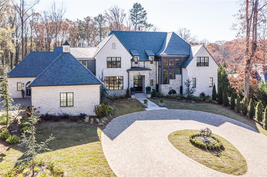 Built in 2018, this magnificent estate home is undoubtedly one of the most exceptional properties to hit the market in recent years. Beautifully sited on a very private 2.4+/- acre lot, the current owners have customized every detail to create a warm and inviting space designed with entertaining in mind. Amenities include a luxurious main level owner's suite with dual custom walk-in closets, elevator access to all levels, a flat walk-out yard with pool and spa, whole house generator & water filtration system, fully finished terrace level with amazing wine cellar & tasting room, media room, yoga/sauna room, and a home gym rivaling any professional sports facility. A spacious terrace overlooking the pool includes an outdoor kitchen, woodburning fireplace plus a seating area with remote screens and shades.  Incredible architectural details throughout include a slate roof, 14 ft ceilings, iron doors & windows, copper gutters and gas lanterns. Ideal location convenient to private schools, shopping, restaurants, and the interstate.  This special home presents the very best quality, style, and design -- every detail is perfection! Truly a rare opportunity for you to have it all.