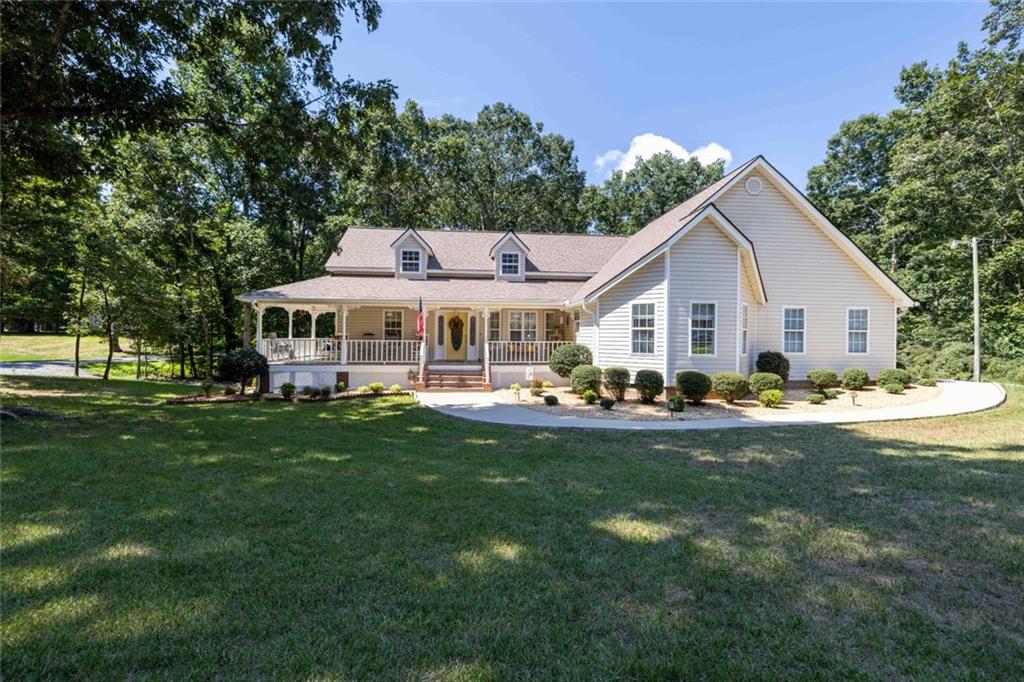 Exceptional North Hall county home, with corner lot. This meticulously maintained home has so much to offer. Starting with a Rocking chair front porch. as you enter, the main level features a large foyer and separate dining area. Large primary suite with office and walk in closet is located on the opposite side of the secondary bedrooms and bath. Large kitchen with refinished solid oak cabinets and tile flooring. Spacious laundry room off the kitchen with added storage. Access to the two car garage is also off the kitchen. Large family room with fireplace and cathedral ceiling is a great place to relax and unwind. The Recently renovated sun room off the main living is a great place for morning coffee, with it's three walls of windows and separate HVAC mini split system. The terrace level recently renovated make it ideal for generational families with a large bedroom and closet, kitchenette, dining and sitting area, washer and dryer closet and new LVP flooring through out. Separate entry with it's own driveway. Additional storage space in the unfinished portion, with inside and outside access. New out building with windows and double doors for storage, lawn equipment or work shop. Also recently installed, Leaf Guard gutter system with lifetime warranty. All this and priced below recently appraised value.