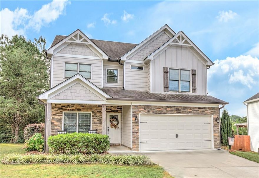 Nestled on a quiet cul-de-sac in the private community of Olde Mill, this gorgeous craftsman style home showcases Amaretto Birch hardwood floors throughout and an inviting open floor plan perfect for everyday living or entertaining. The spacious kitchen features stainless steel appliances, crisp white cabinetry, a tile backsplash, and a custom island with seating, all with views of the fireside family room and breakfast area. The formal dining room offers the perfect setting for hosting family and friends.

The oversized owner’s suite impresses with vaulted ceilings, sliding barn door, dual vanities, a standing shower, a large soaking tub, and a huge walk-in closet—all enhanced by a serene mountain view. Step outside to enjoy the private backyard from the expansive deck, ideal for relaxing or entertaining.

Conveniently located just minutes from Historic Downtown Ball Ground, Canton Marketplace, and Cherokee Hospital, this home combines privacy, comfort, and convenience in one exceptional setting.