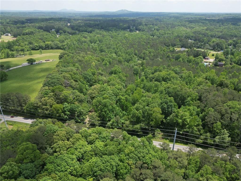 TWO PRIME RESIDENTIAL TRACTS NOW AVAILABLE IN EAST PAULDING!!! This listing is for BOTH Tracts 1 (1.111 acres) and Tract 2 (1.100 acres) -- see recorded plat in documents. Each lot offers a rare opportunity to build in a fast-growing corridor with NO HOA. Gently sloped, wooded terrain with excellent frontage on Dallas Acworth Hwy. Ideal for a custom home, builder project, or long-term investment. Located just minutes from Hwy 92, Hwy 120, I-75, Downtown Dallas, and Lake Allatoona. Enjoy nearby shopping at Costco, Publix, and Walmart, plus local dining at Rodney’s BBQ. Just a short drive from dining, shopping, and more in North Paulding, Hiram, Dallas, and West Cobb! Zoned residential with public utilities nearby (buyer to verify). Soil report and recorded survey available in MLS documents. Zoned for Abney Elementary, Moses Middle, and East Paulding High.