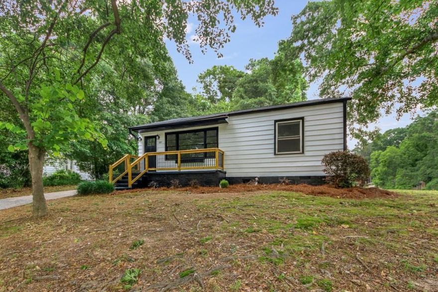 Charming Cottage in Convenient Marietta Location! Completely and Tastefully Renovated, this cottage is within walking distance to Six Flags White Water, and a short drive to Marietta Square. This home is light and bright, every room updated with flooring, paint, and fixtures. You'll enjoy cooking in the beautiful kitchen with quartz countertops, a large sink, and a gas range. Beadboard in the updated bathroom brings some character to this quaint home. A back patio overlooks a large flat lot that would be great for outdoor entertaining. This is an amazing MOVE-IN READY Home in Marietta at a great price! You'll love all this home has to offer.