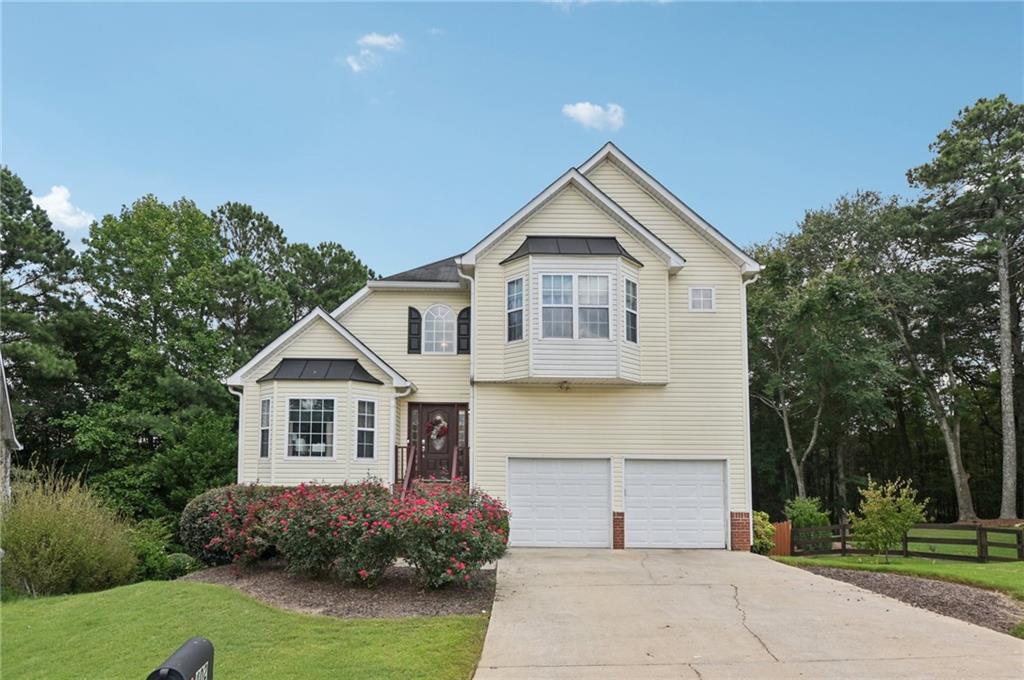 Welcome to 402 Towne Valley Drive, located one mile from Downtown Woodstock. This stunning 4-bedroom, 3.5-bathroom home perfectly blends comfort, function, and style. From the moment you enter, the two-story foyer and great room fill the space with natural sunlight, creating an open and inviting feel. The spacious primary suite offers a luxurious bathroom with a separate shower and soaking tub, while three additional bedrooms provide plenty of space for family, guests, or a home office. The finished basement is a highlight, complete with its own bedroom, full bathroom, kitchenette, and separate living room, along with a private entryway that makes it ideal for an in-law suite, guest quarters, or rental potential. Outdoor living shines with a large backyard featuring a cozy fire pit, a beautiful porch overlooking the yard, and a concrete patio, perfect for relaxing or entertaining. A 2-car garage offers ample parking and storage, while the location in the heart of Woodstock provides convenient access to local parks, shopping, dining, and top-rated schools. Minutes from highway 575.