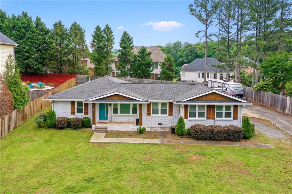 Welcome home to this beautifully updated 3-bedroom, 2-bath brick ranch situated on a spacious and private lot in a convenient Cobb County location. Enjoy easy access to local shopping, restaurants, and everyday amenities, all while tucked away in a peaceful neighborhood with no HOA restrictions. Inside, the open-concept layout offers a seamless flow and maximizes every inch of space. The large family room connects effortlessly to the dining area and the newly renovated kitchen. Bright and airy, the kitchen features stainless steel appliances, granite countertops, a center island, and a cozy breakfast area perfect for casual dining. The oversized primary bedroom is a true retreat, featuring sliding barn doors that open to a stylish en suite bathroom complete with double vanities and a large walk-in shower. A thoughtful split bedroom plan provides privacy, with two additional bedrooms that are ideal for guests, family members, a home office, or hobby space. Step outside and enjoy a variety of outdoor living options. Relax on the covered front porch, or entertain in the expansive screened-in back patio complete with an outdoor kitchen. The fully fenced backyard is perfect for pets, play, or gardening. A two-car attached garage adds everyday convenience. This home blends classic charm with modern upgrades and plenty of room to spread out, both inside and out. Don't miss your chance to own a move-in ready gem in a prime location.