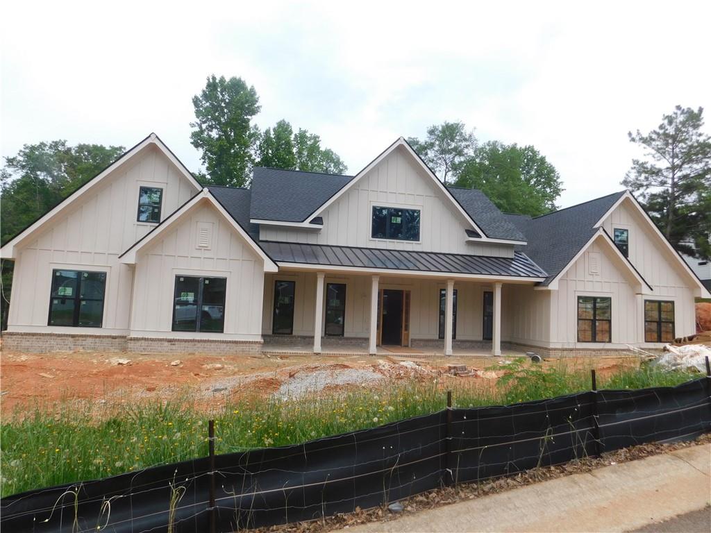 AMAZING custom Modern Farmhouse design in the estabilished Sandy Creek golf course community in North Jackson County, close to Athens. This beautiful floor plan provides 4 bedrooms on the main level with a bonus and full bath on the upper level. The office and dining room great you upon entry into the impressive foyer that leads you to the Open concept which lays across the back of the home with picture windows, gourmet custom kitchen with quartz counters, pot filler, large island and double ovens. The living area offer wood style flooring, wetbar, accent walls recessed lighting along the trey ceilings. Primary suite provides peace and quiet in its own wing with a luxury bath offering a bidet, large tiled shower & separate stand alone tub. Secondary bedrooms on main with one ensuite with own entry. Large bonus room on second level with a full bath. This design provided covered porches flanking the front and back. This design flows effortlessly that is sure to please.